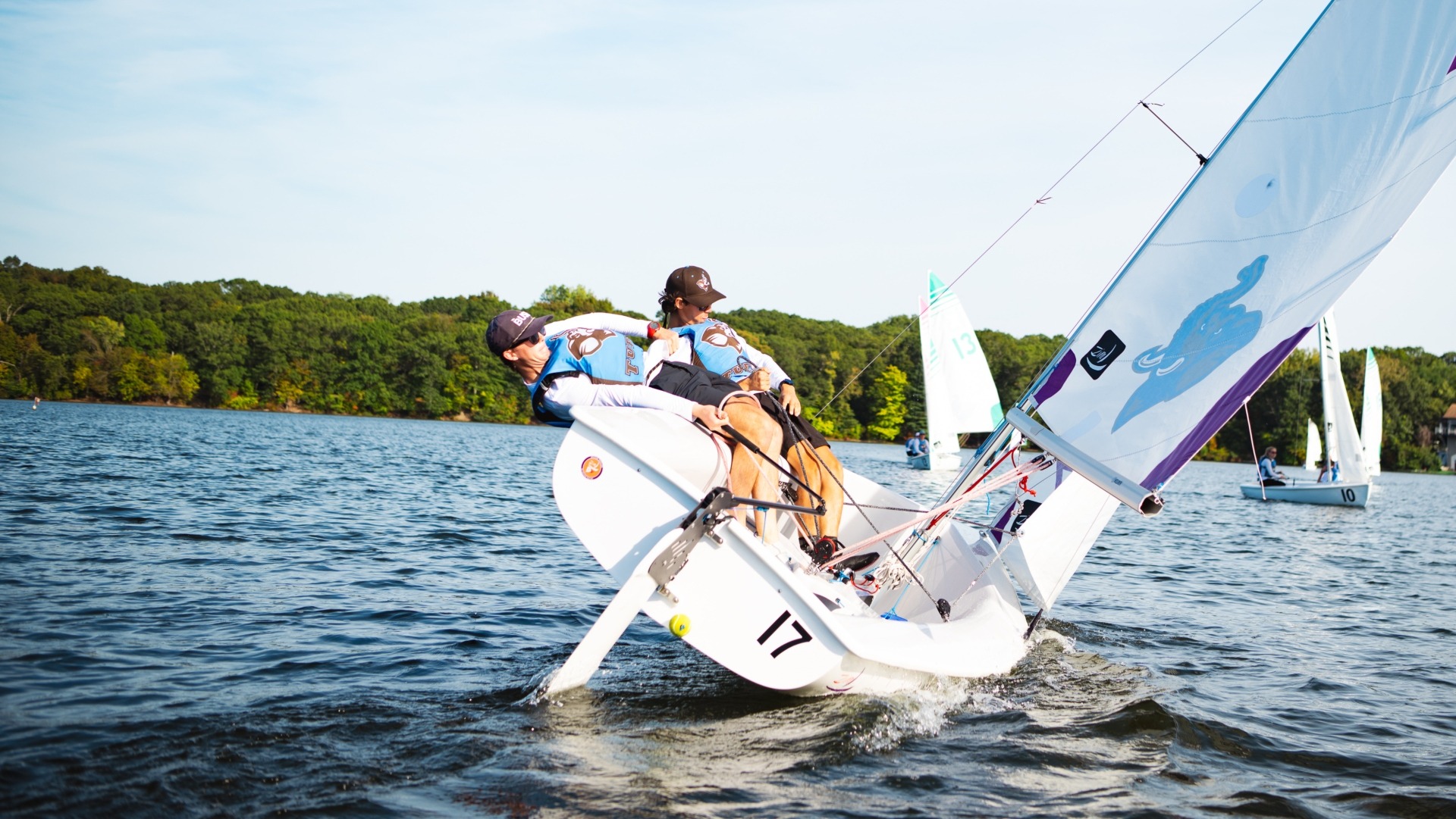 Pearse Dowd and Sean Beaver sail on Upper Mystic Lake at a team practice.