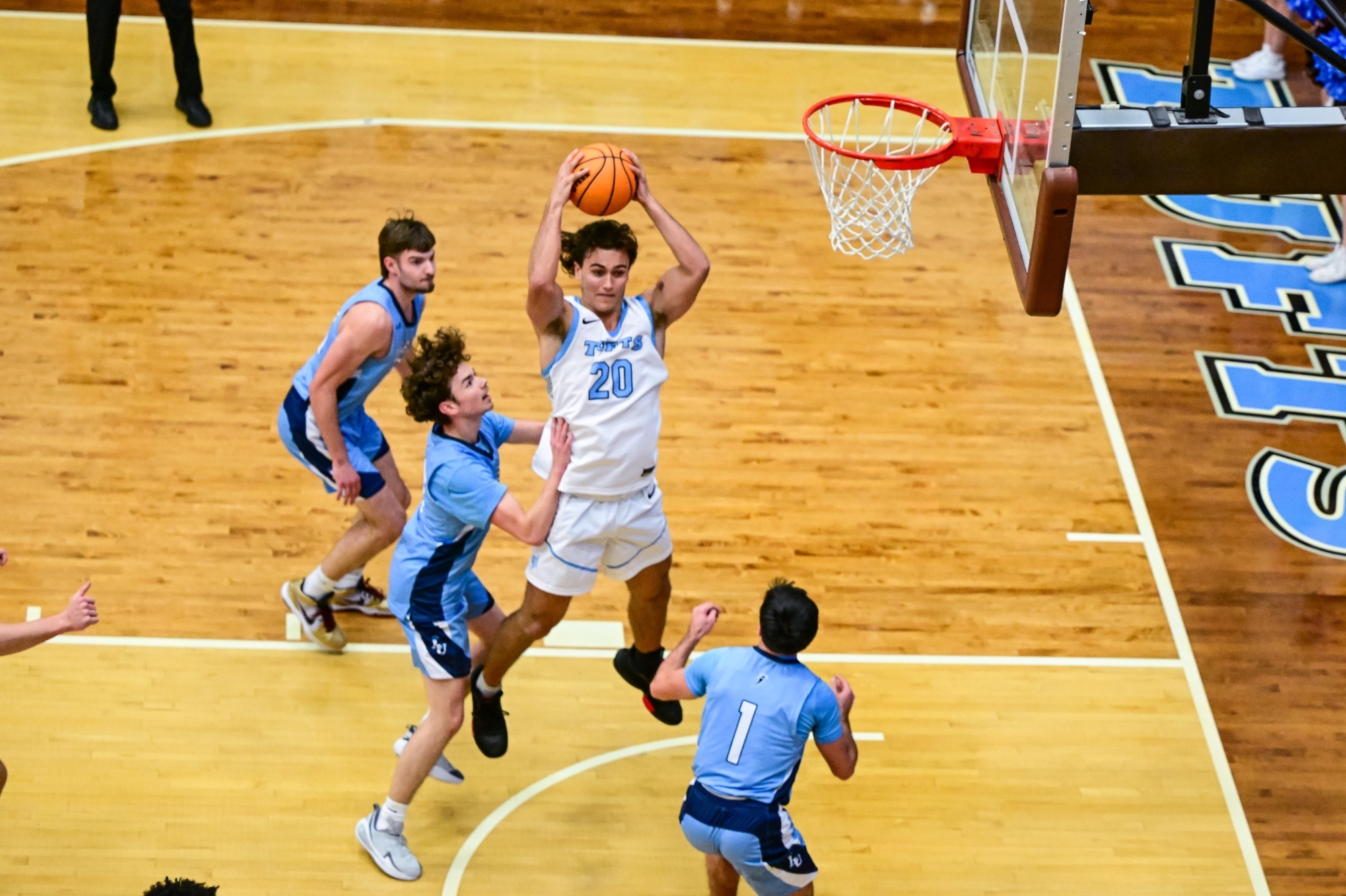 Scott Gyimesi grabs a rebound at Cousens Gym.