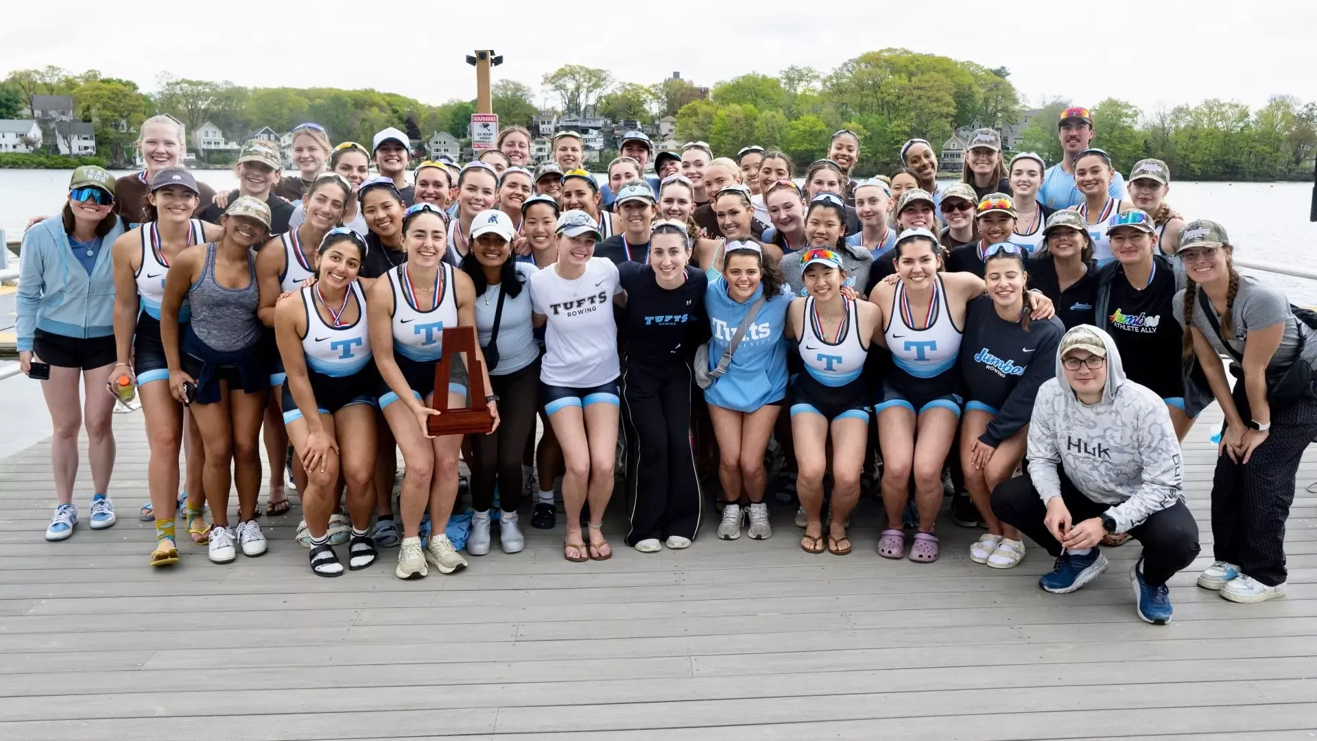 The Tufts women's rowing team celebrates finishing as the NESCAC runner-up.