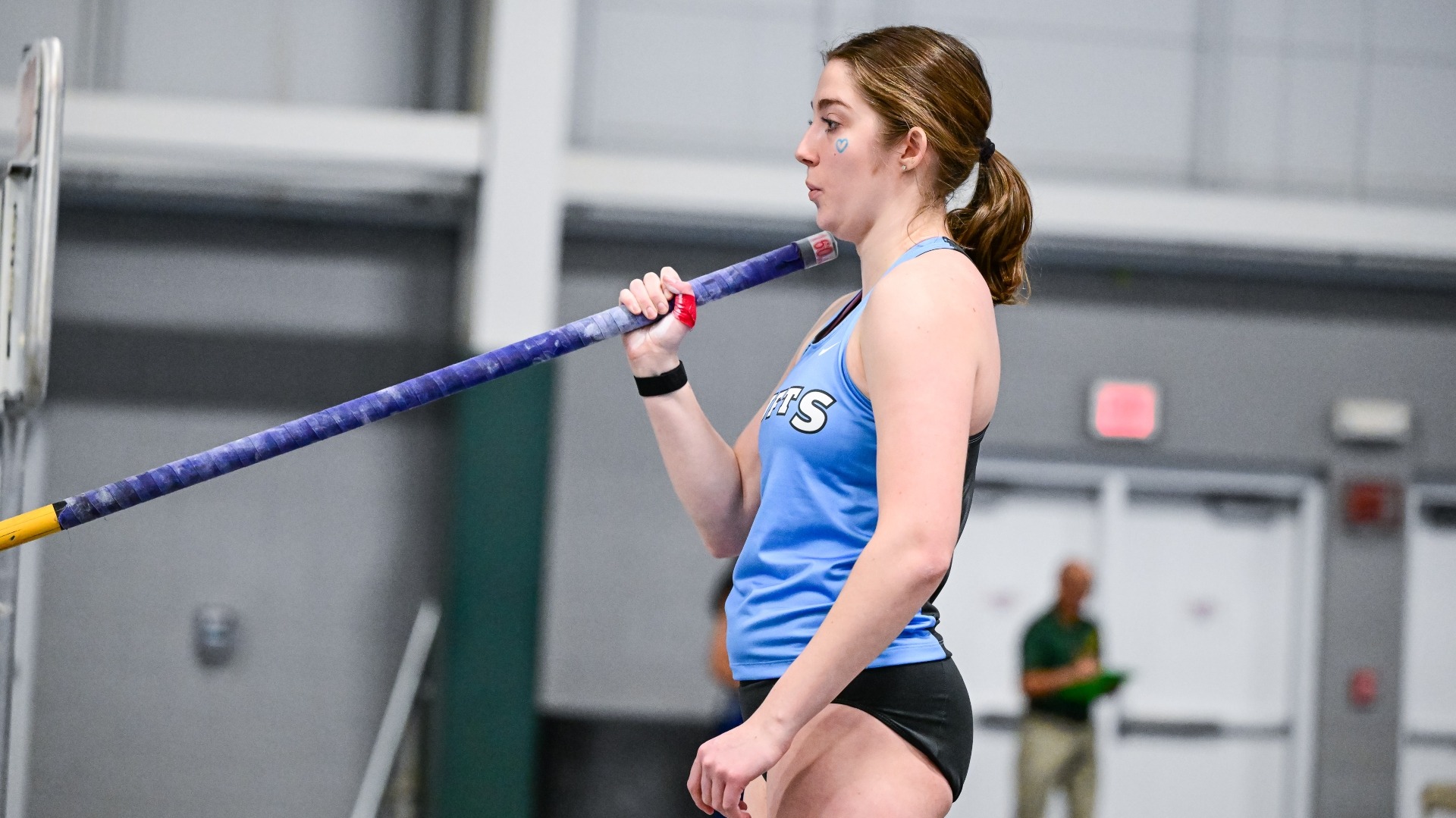 Emma Galls prepares to head down the runway in the pole vault event.