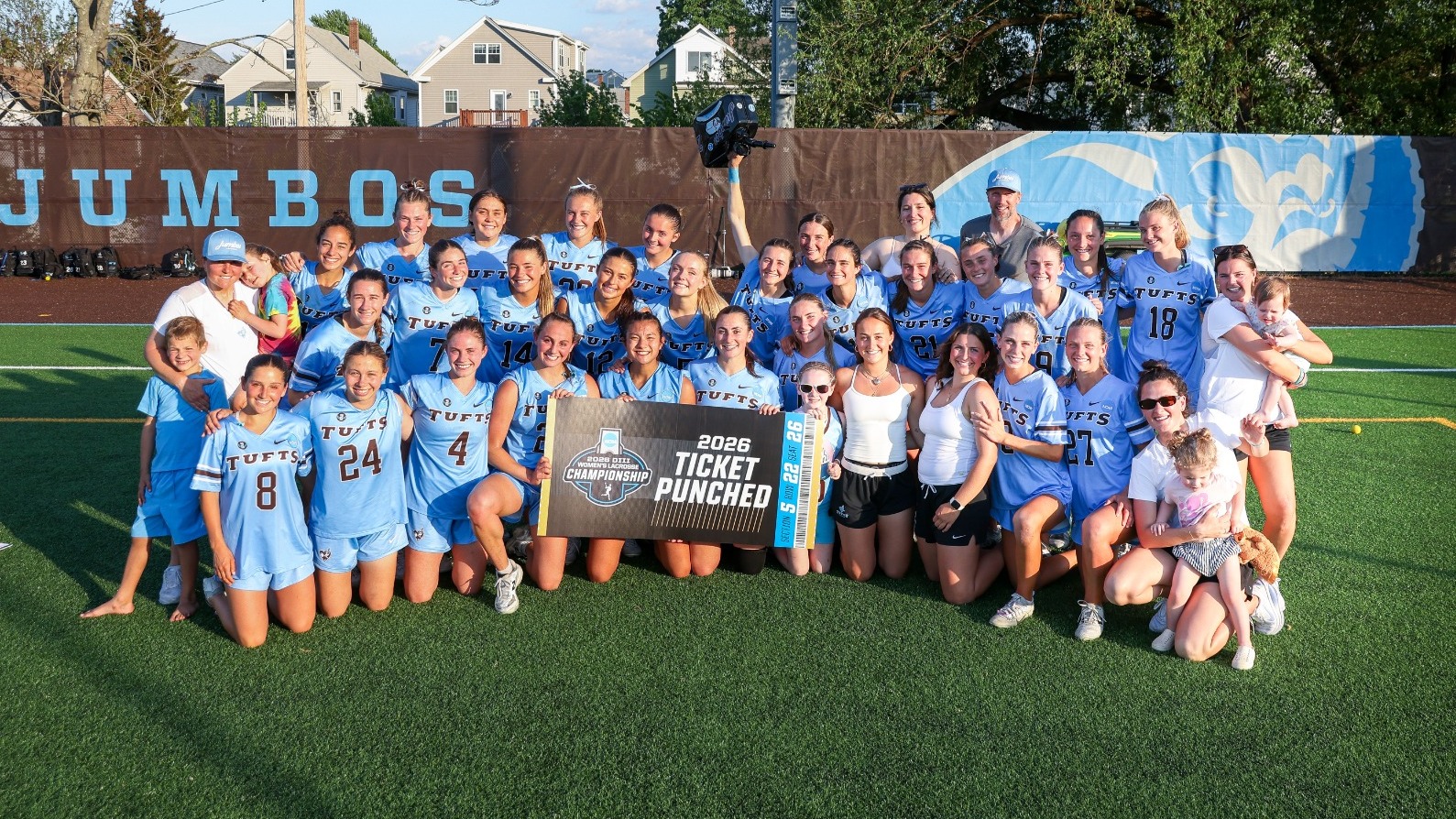 Tufts women's lacrosse holds Ticket Punched sign after defeating Williams Sunday, May 17, 2026.