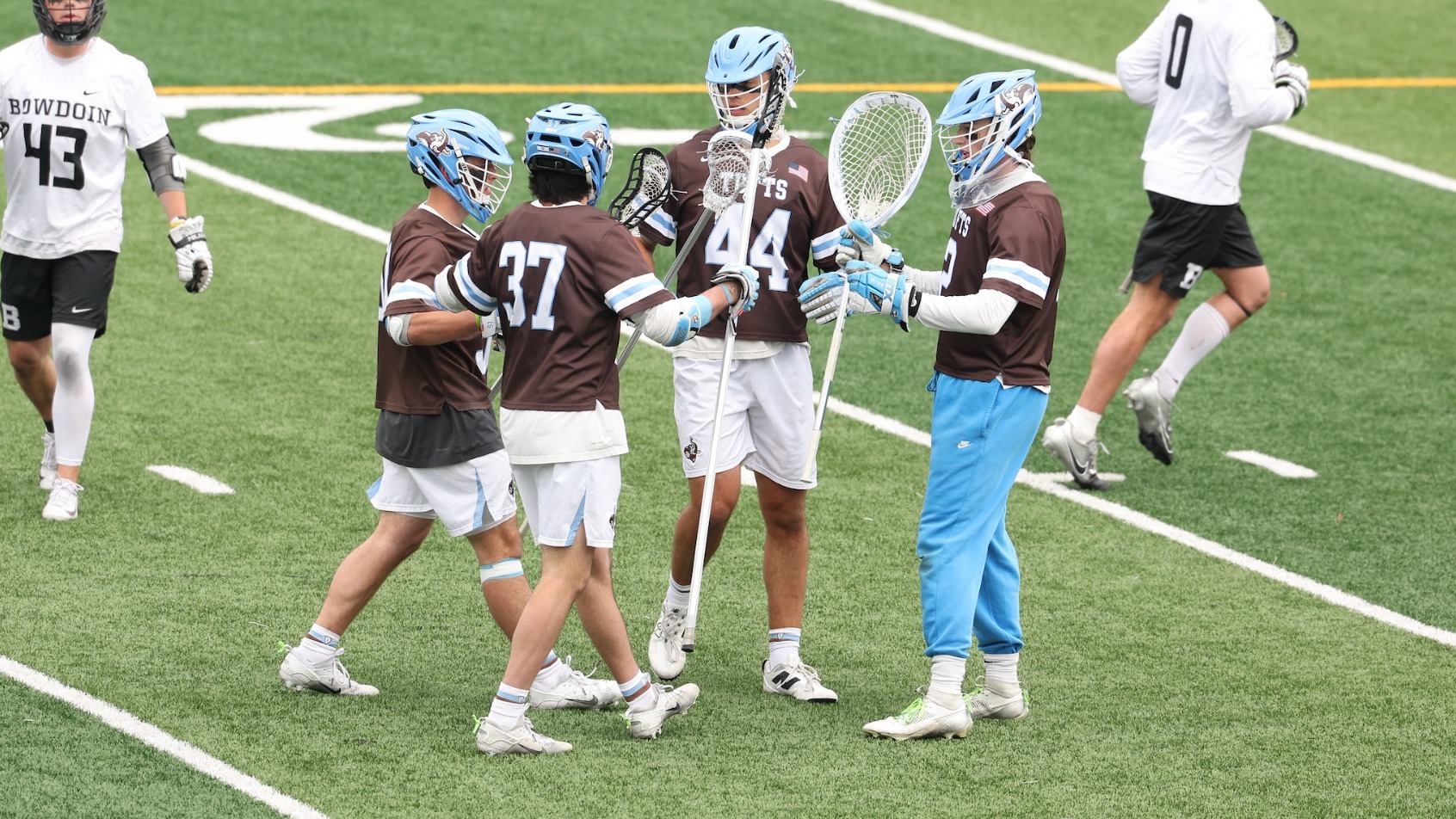 Tufts Defensive Unit Huddles After Goal Sunday, May 3.