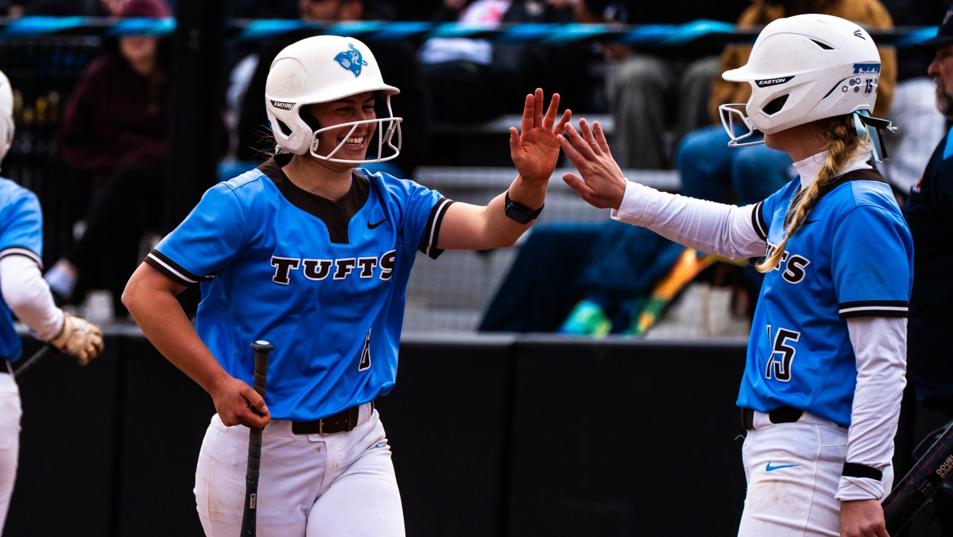 Haley Leimbach and Ella Malin celebrate a Tufts run recently at Spicer Field.
