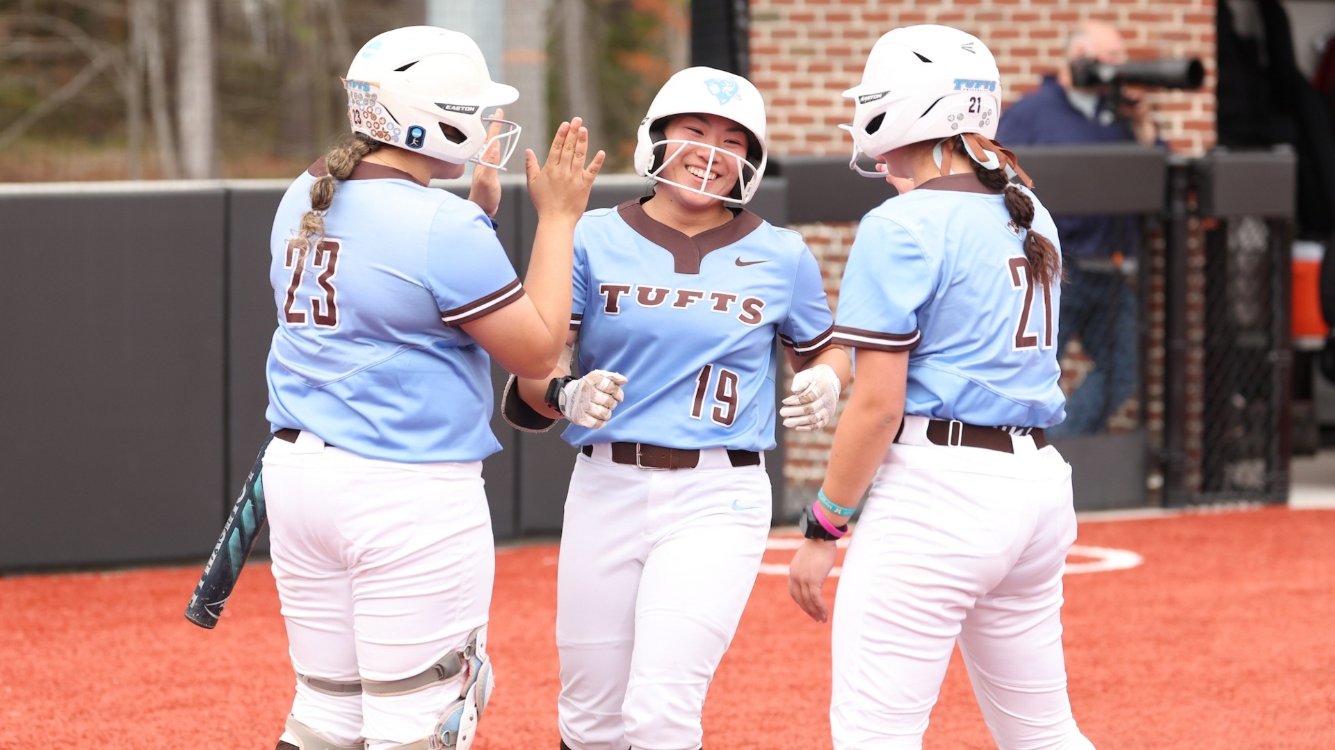 Lauryn Horita is greeted at the plate by her teammates after a home run in the NESCAC Quarterfinal.