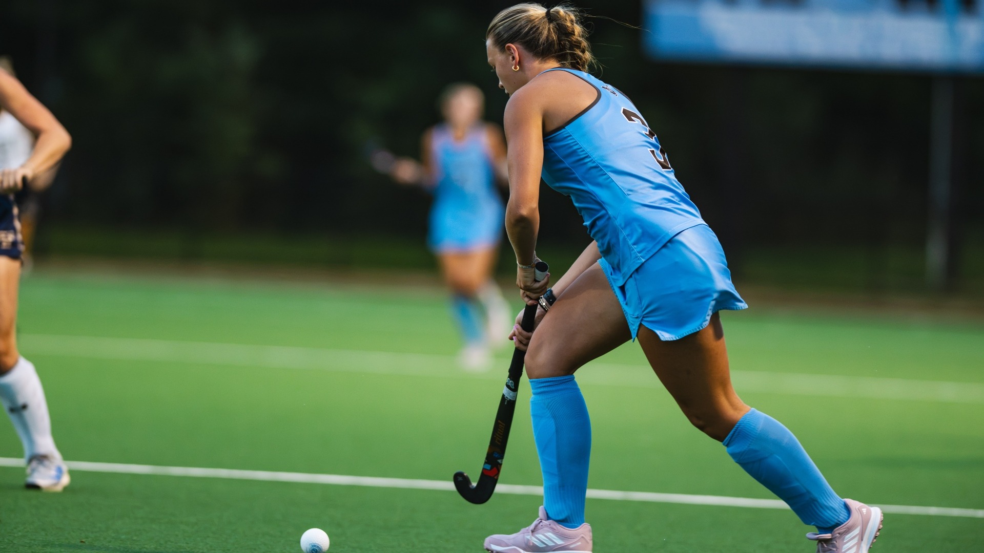 Eleanor Helm dribbles in on goal against Trinity College.