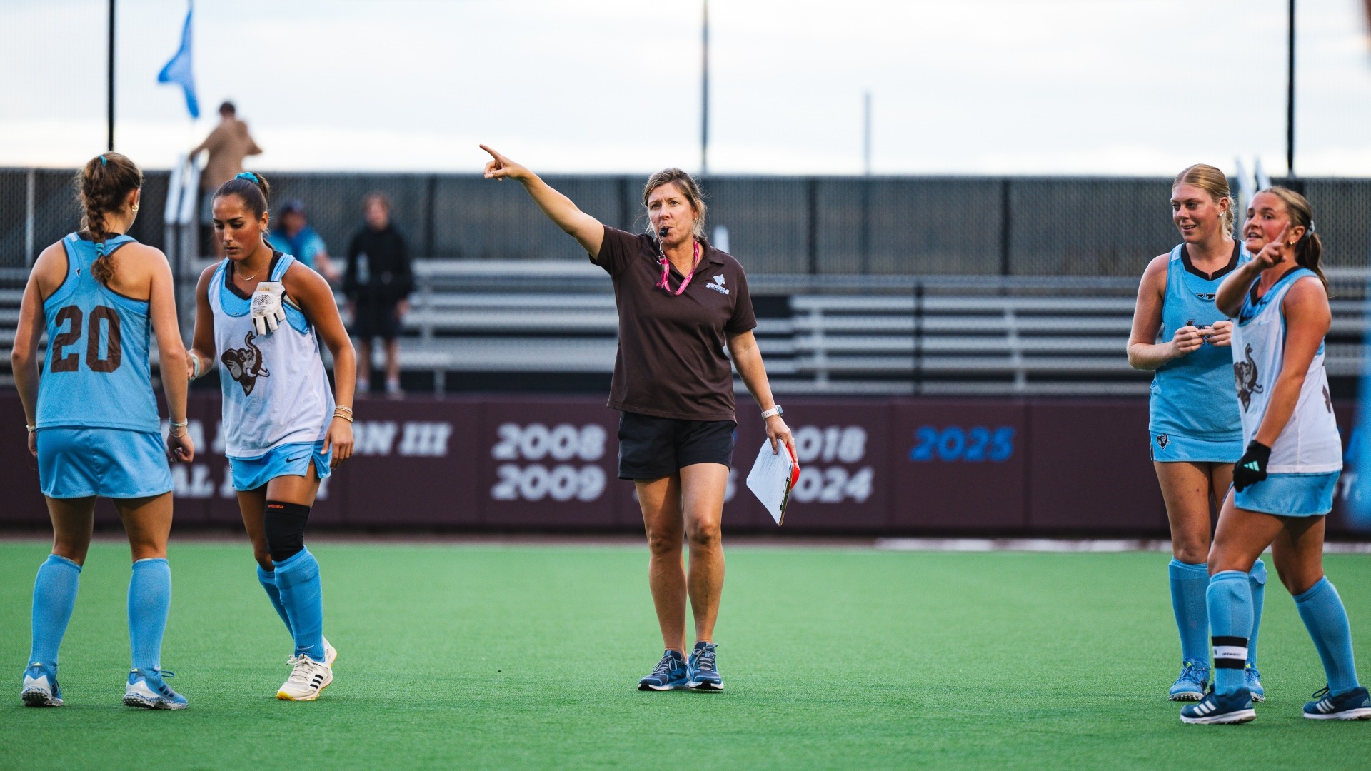 Head coach Tina Mattera instructs her team prior to the game against Trinity.