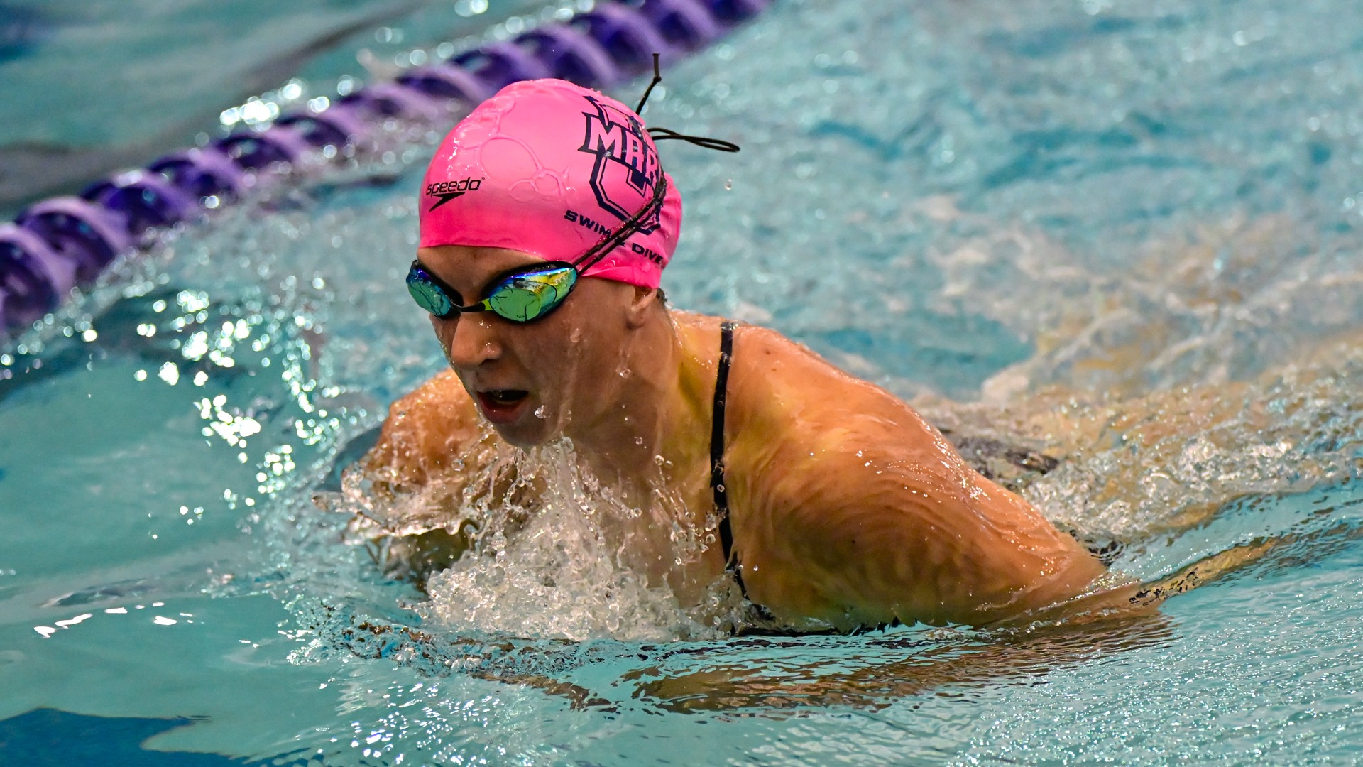 UMary swimming competing in breaststroke