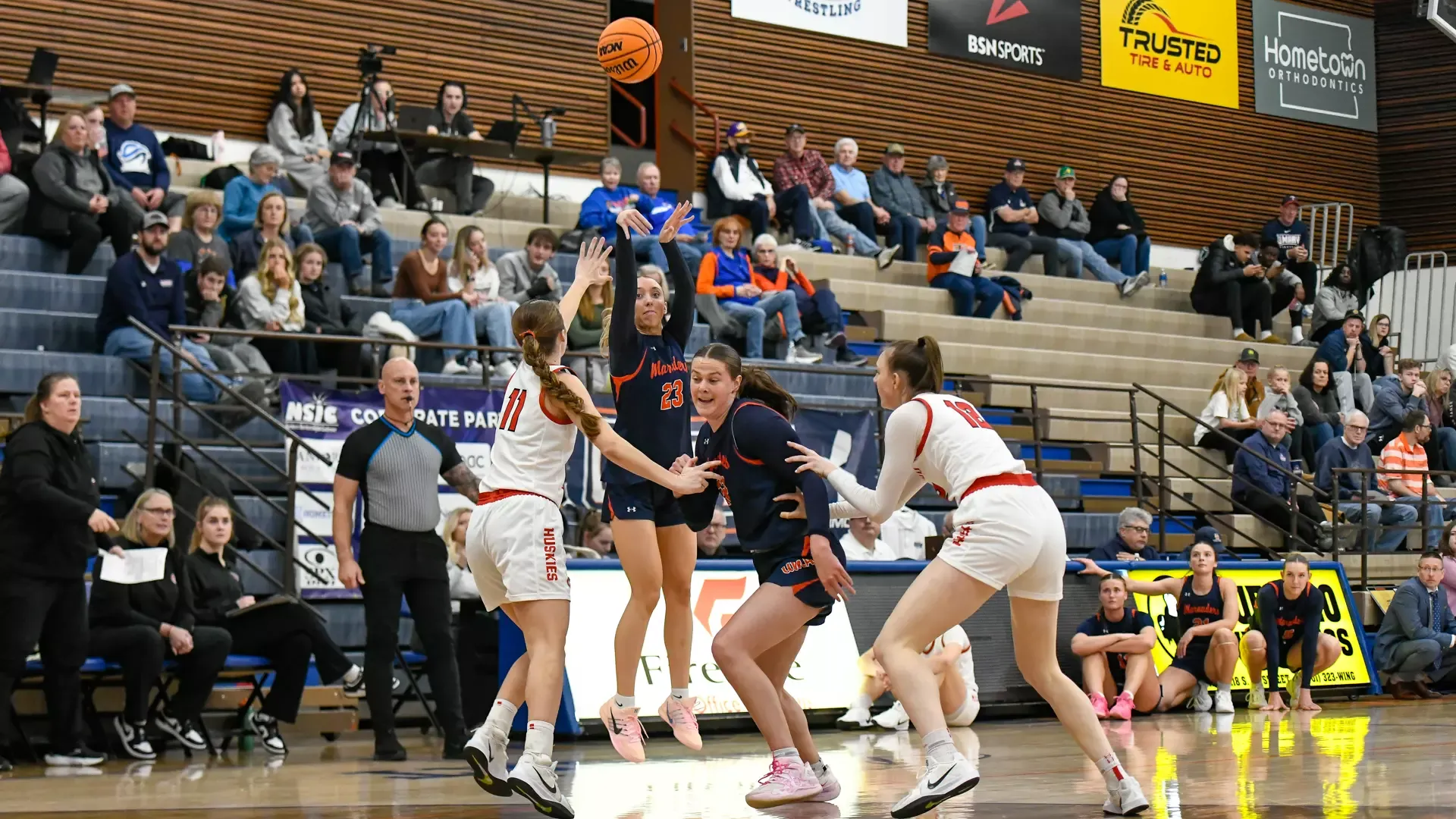 Emily Jaenke fires a three in front of SCSU bench