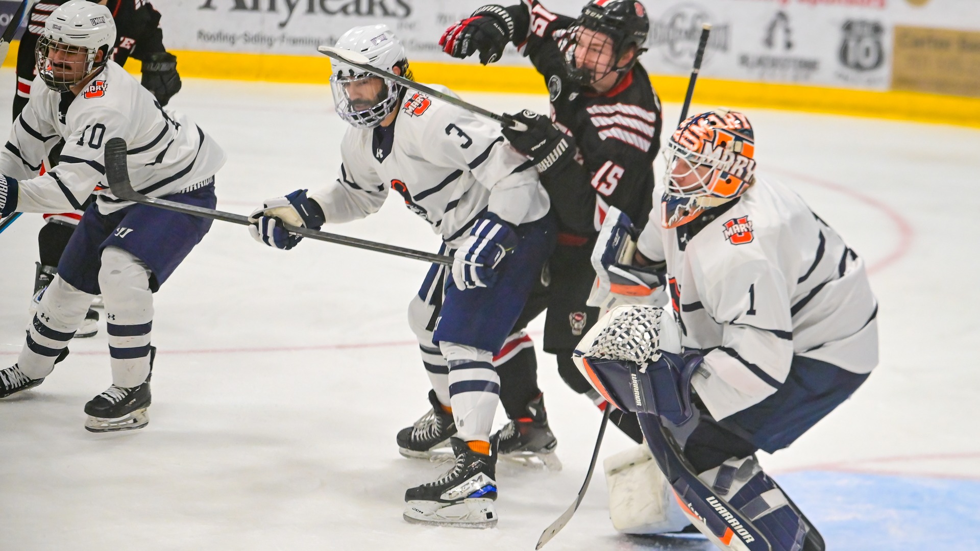 Amraj Gill and Caleb Cross protect the net
