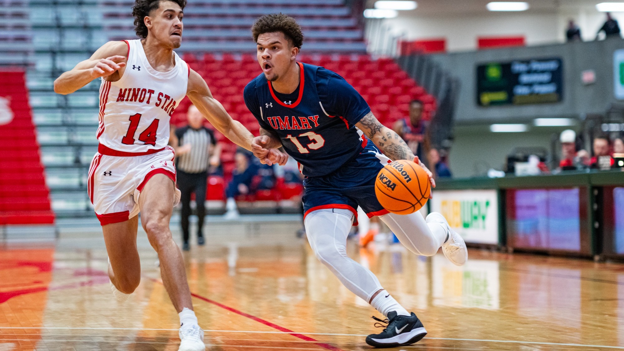 Tamarrein Henderson drives past defender