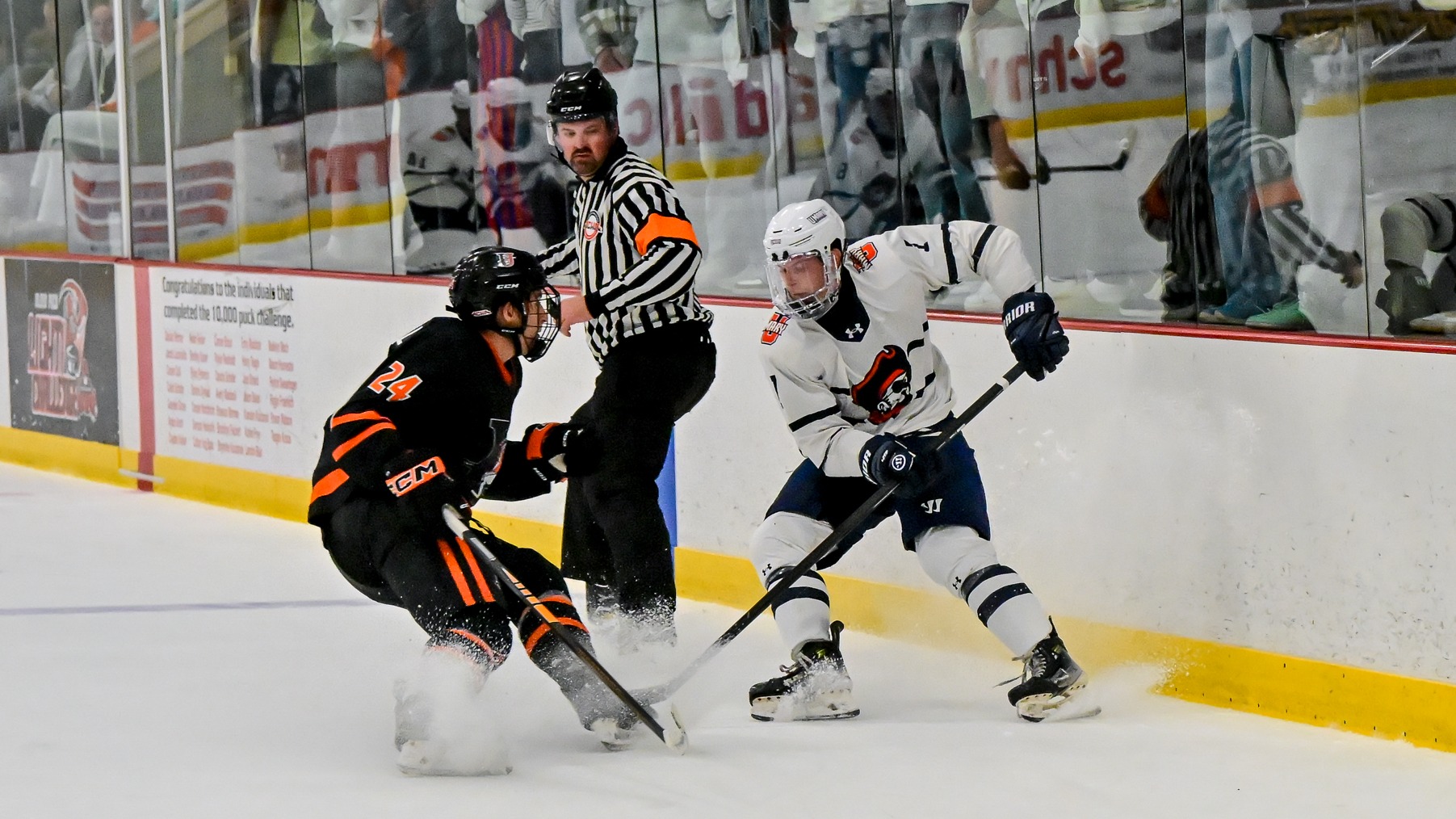 Andrew Brubakken fights for puck