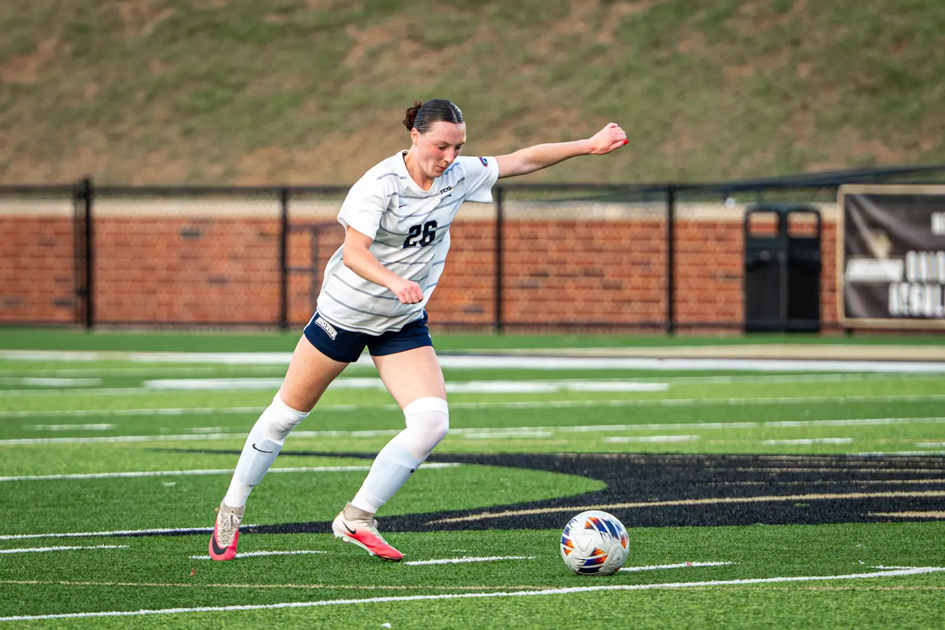 USI Women's Soccer Tierney Mullady kicking the ball against Lindenwood.