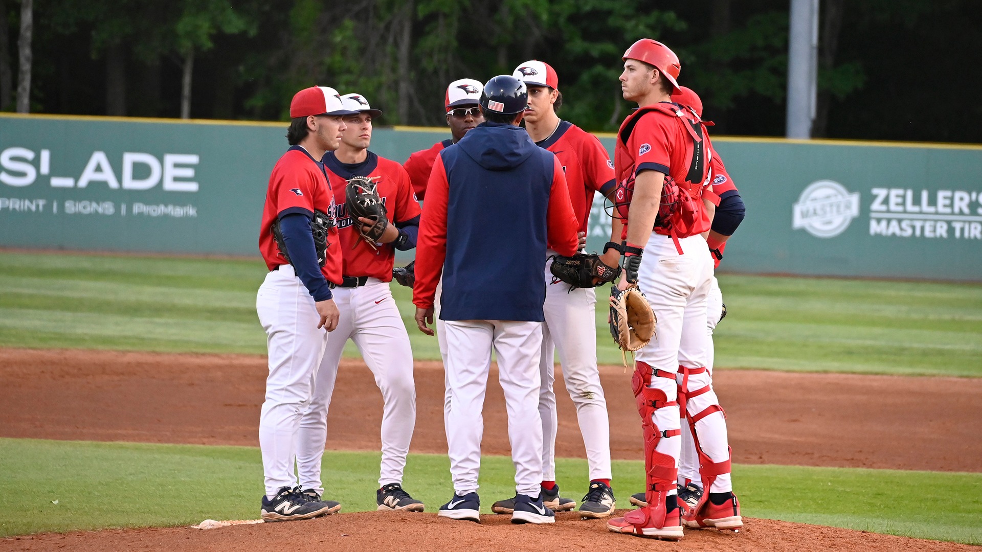 USI Head Coach Chris Ramirez talks with Ryan Weller on the mound vs. TTU