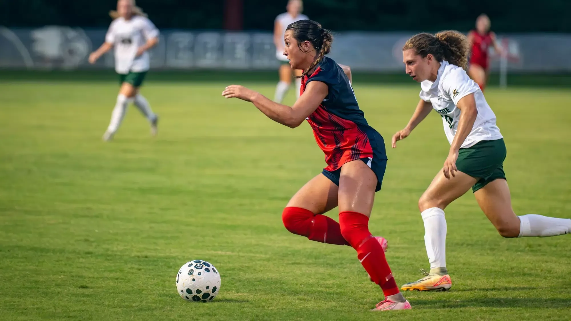 USI Women's Soccer defender Emma Schut dribbling the ball.