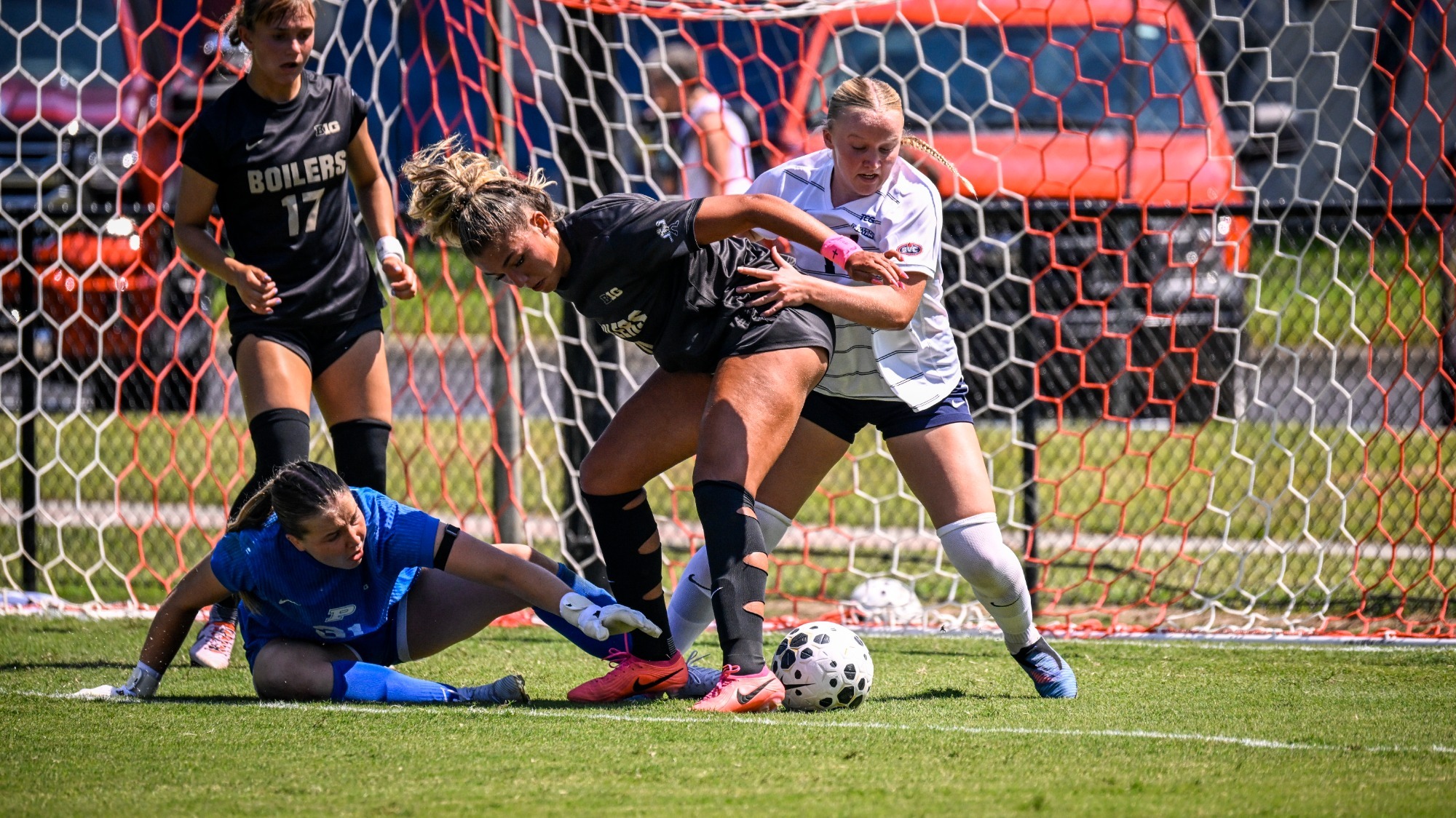 USI Women's Soccer midfielder Elle Leece battles for loose ball in front of the goal against Purdue.
