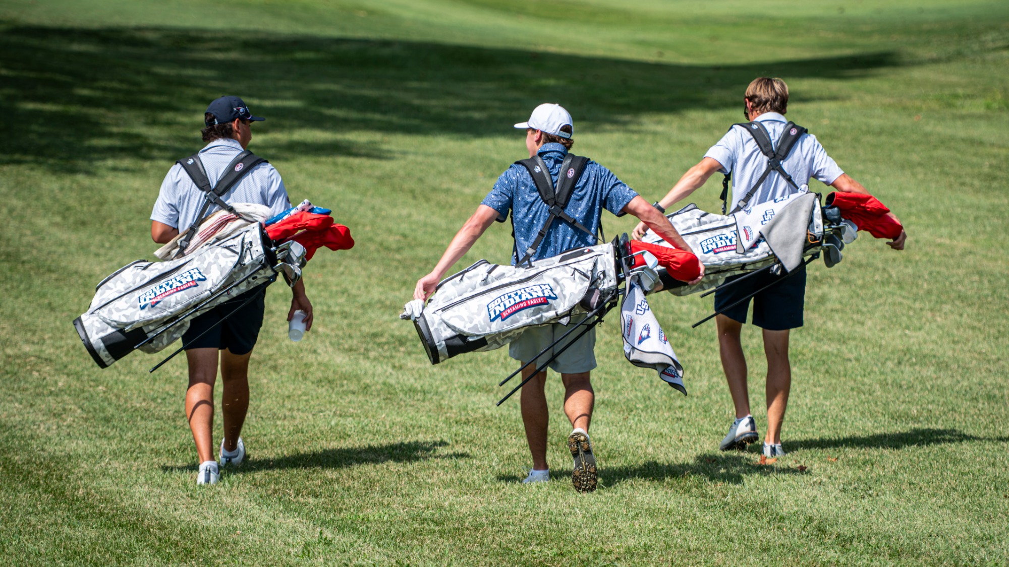 USI Men's Golf players walking with new bags during a practice round on August 27, 2026.