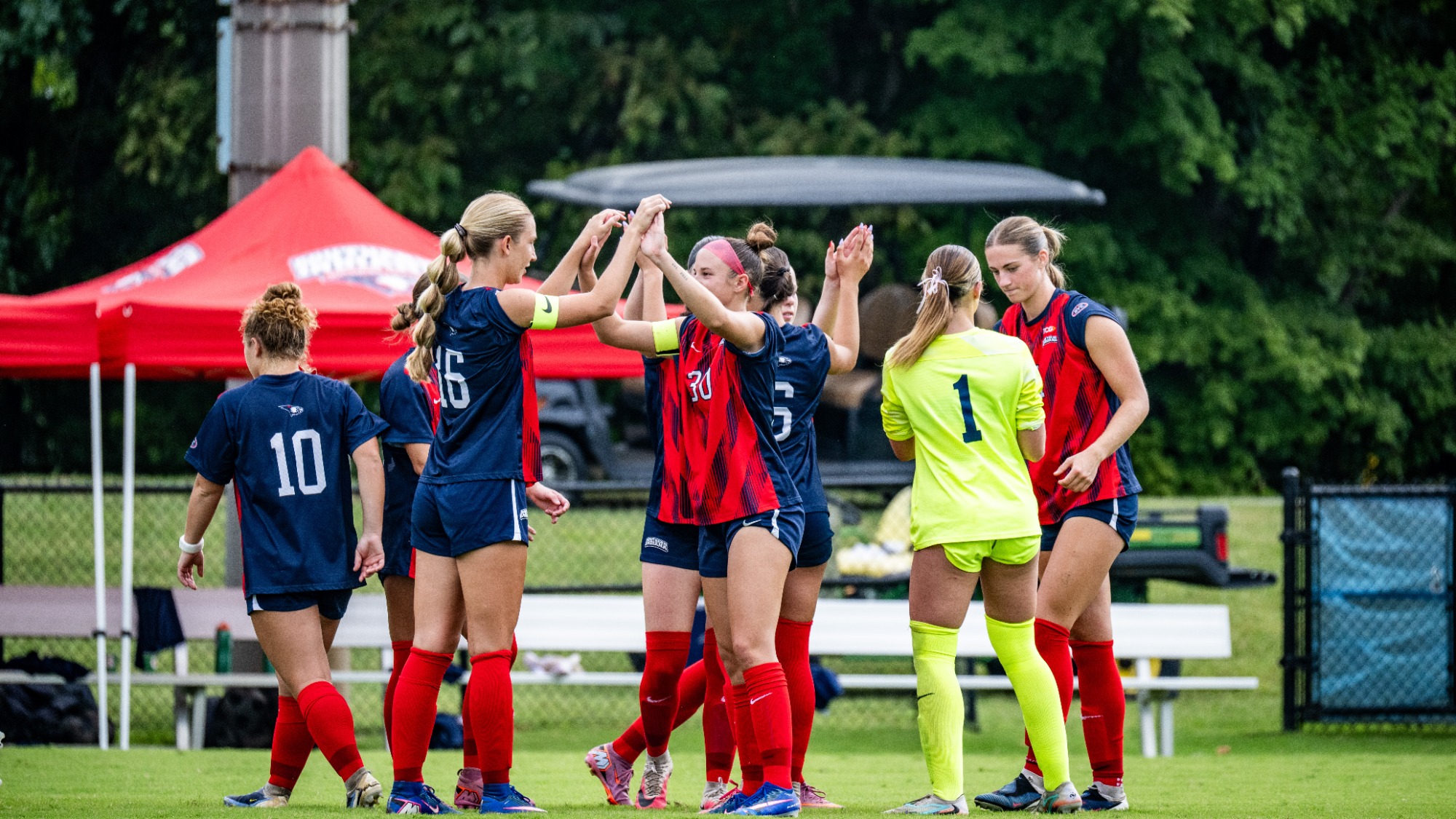 USI Women's Soccer pregame Eva Boer and Kamryn Bea high five vs. Xavier
