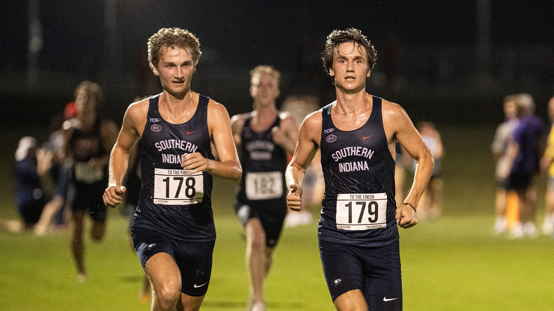 Jackson Nolan (right), Alex Nolan (left) and Ben Perulfi (background) raced to a 1-2-3 finish at the 2026 Stegemoller Screagle Twilight at the USI Cross Country Course in Evansville, Indiana, on September 4.