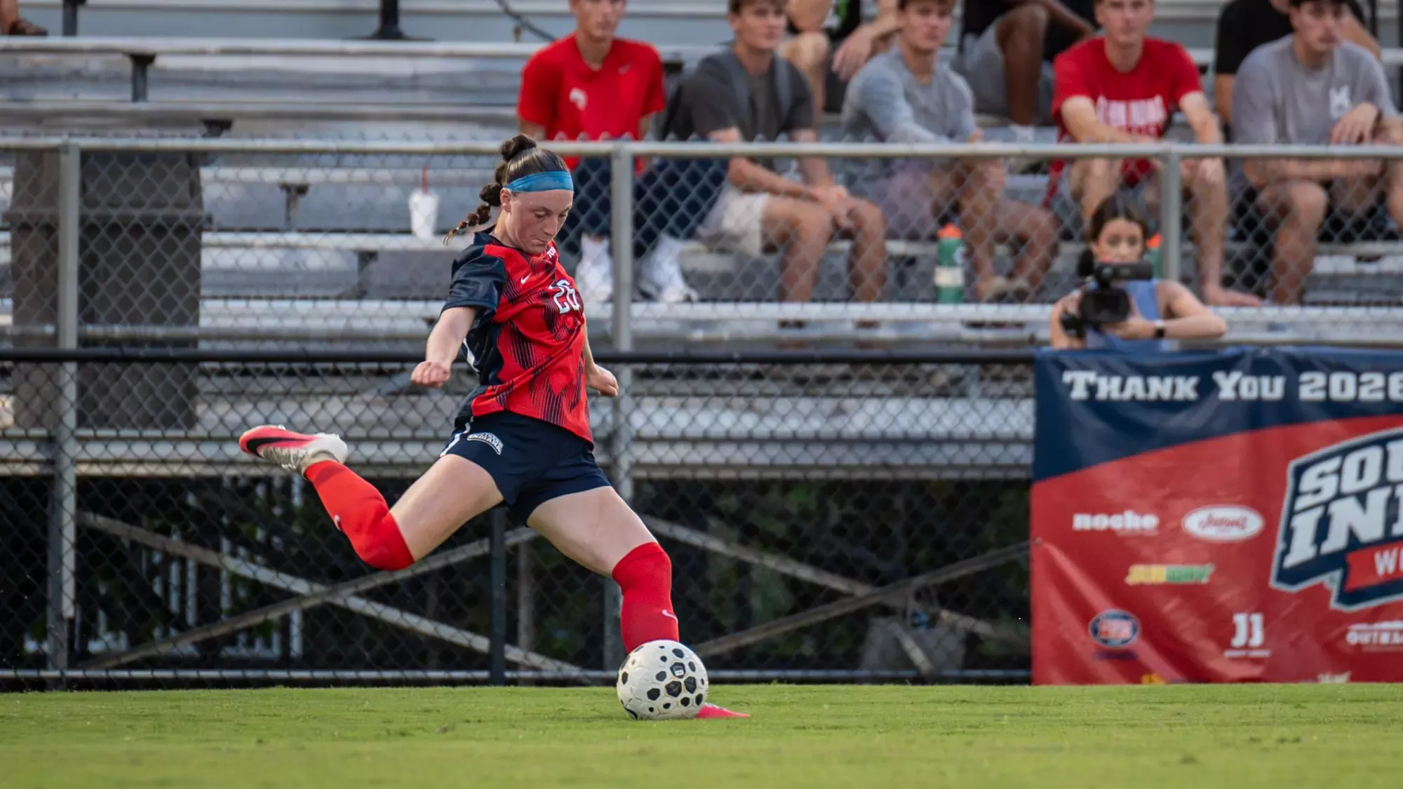 USI Women's Soccer Tierney Mullady kicking the ball against Arkansas State.
