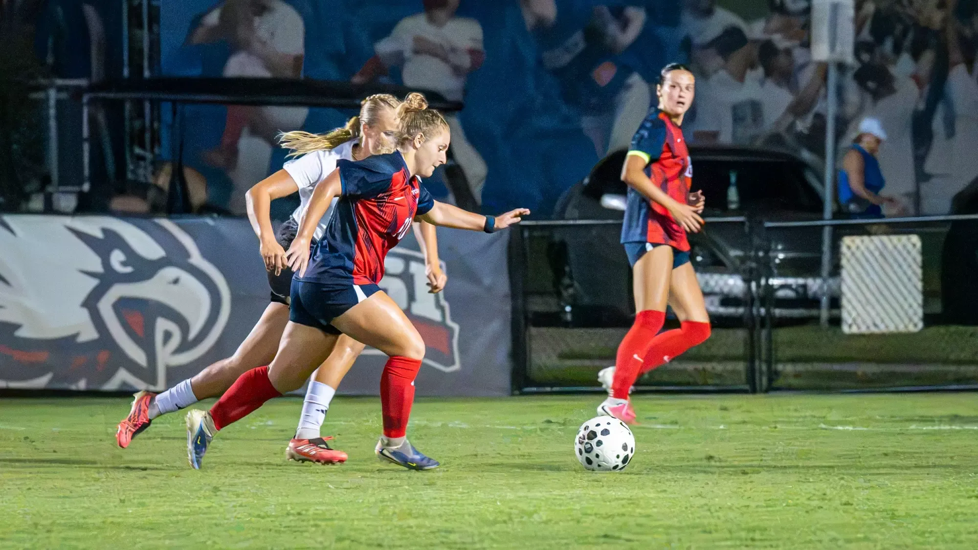 USI Women's Soccer Shea Krakowski kicking the ball against Arkansas State.