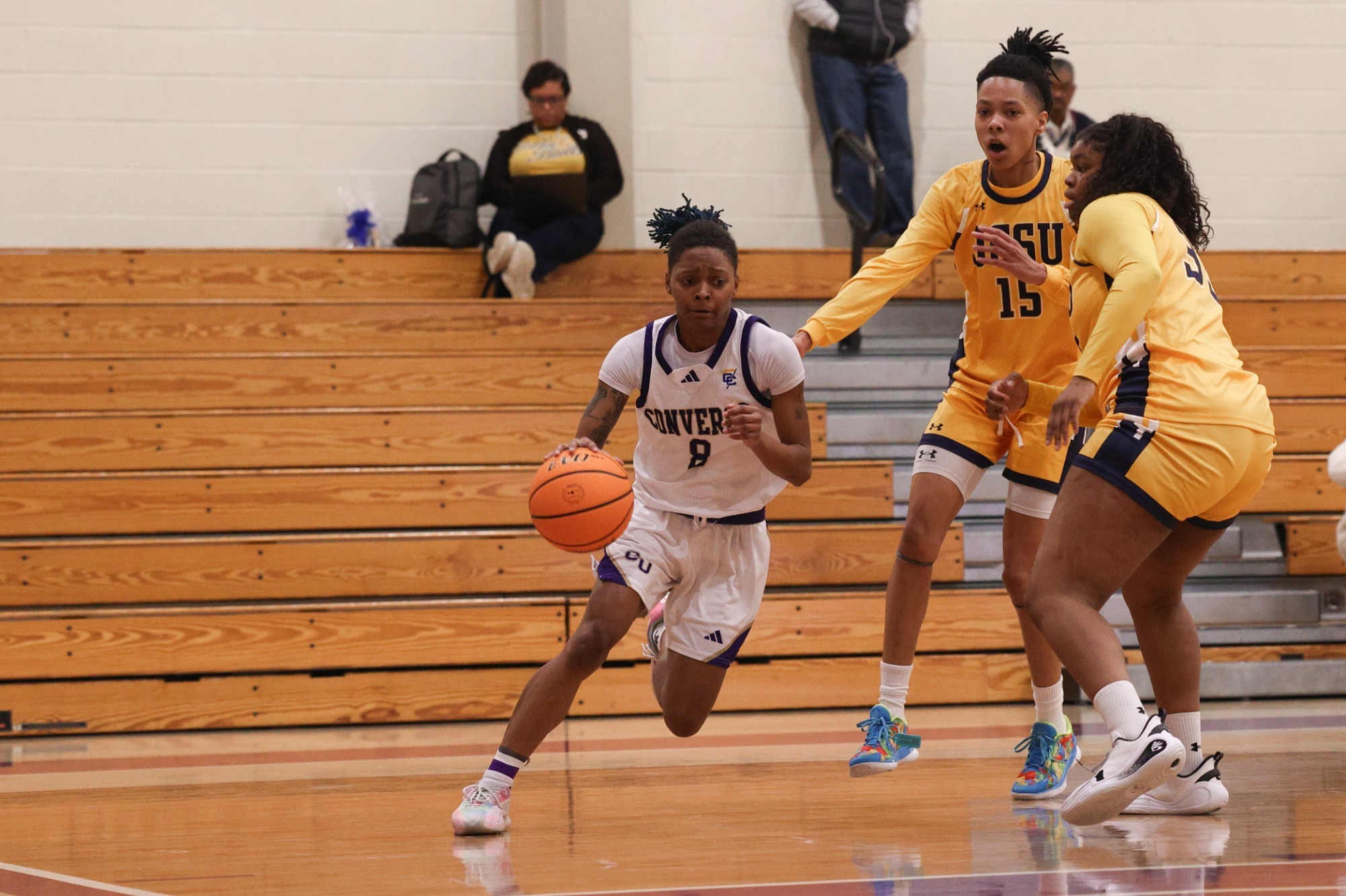 Rayanna Evans dribbles past two JCSU defenders
