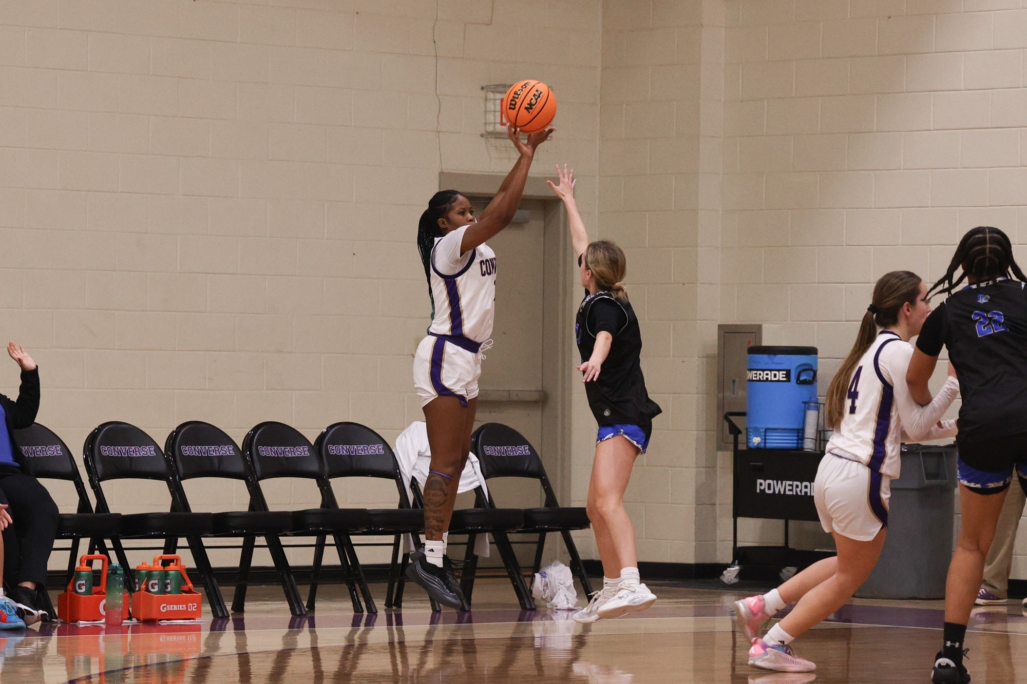 Jaclyn Wright-Thompson attempts a three pointer over a Southern Wesleyan defender