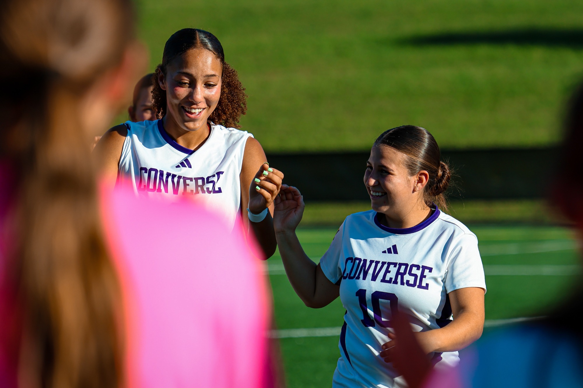 Sierra Criner and Varinia Delgado share a laugh prior to a game