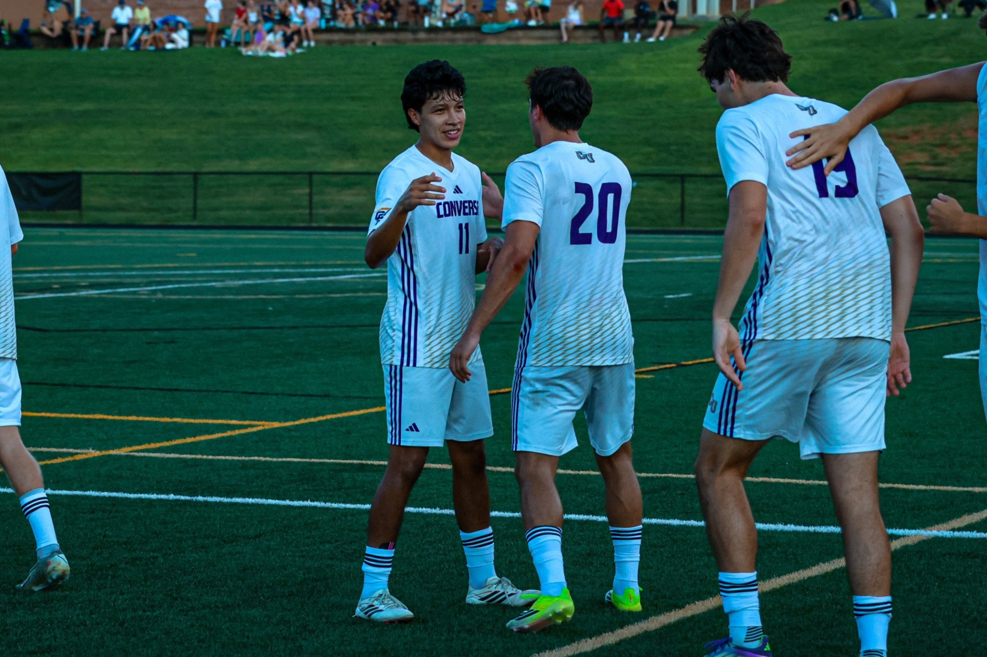 Andy Alvarenga and Raphael Schneider celebrate a goal with a high five