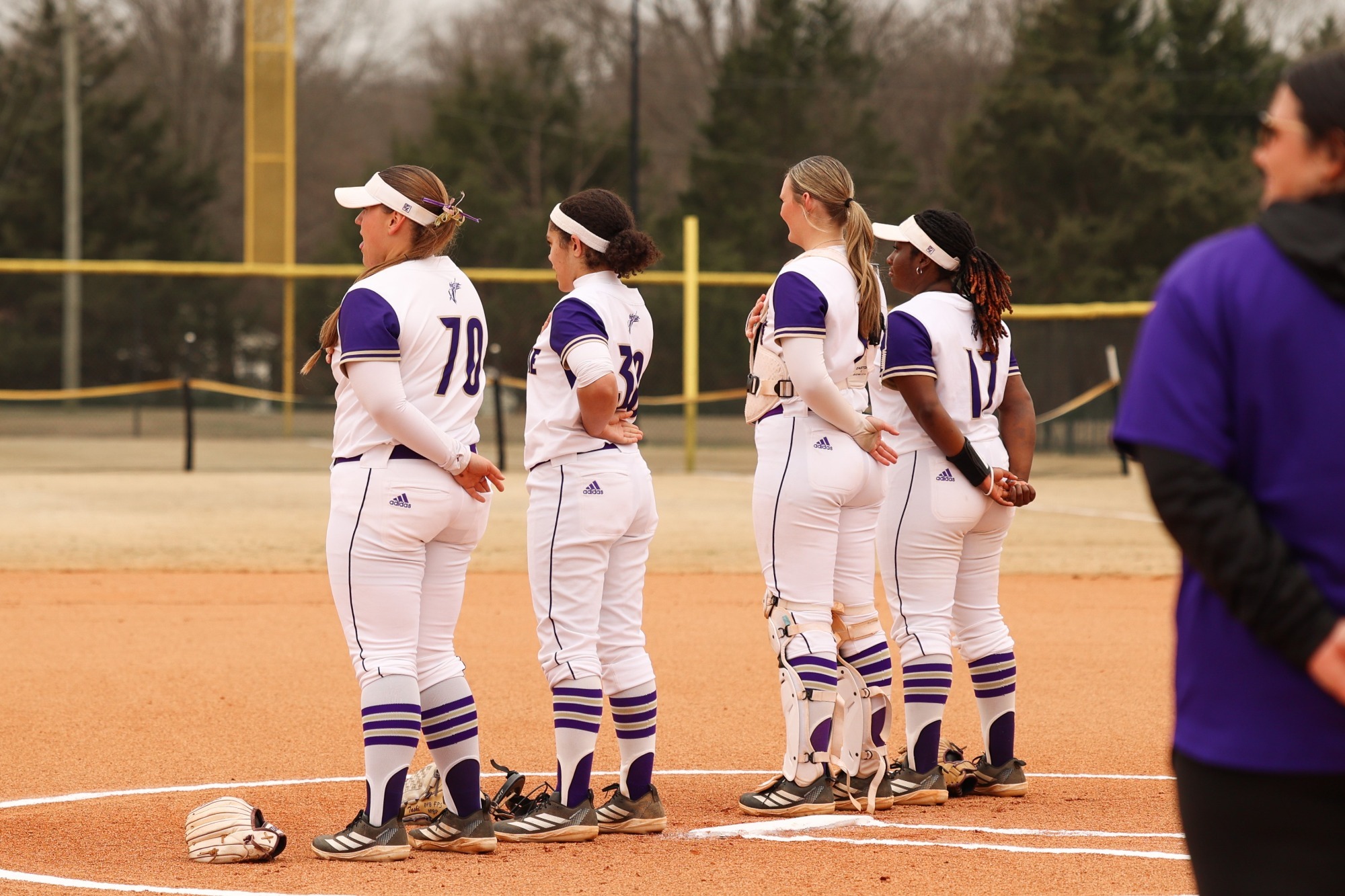 Madison Davis, Tashi Fife, Alexis Felker and Kiarra Thomas stand in the circle for the national anthem
