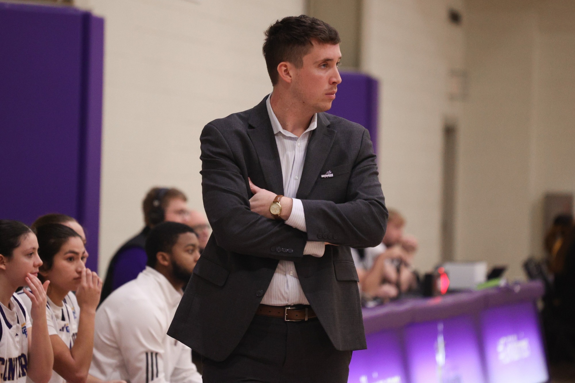 Kevin Lyons coaches in a nice suit on the sideline at the Weisiger Center