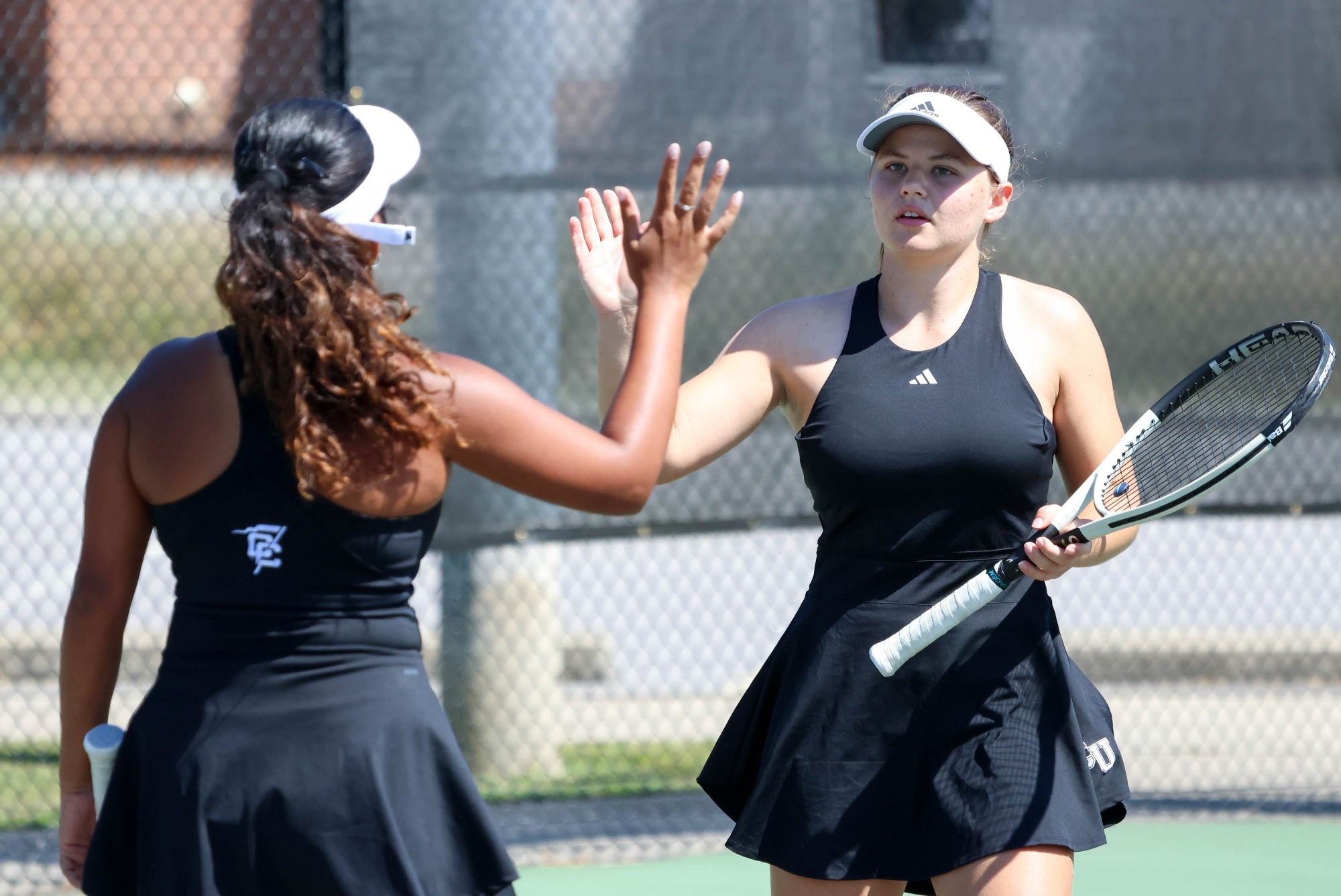 Romy Rueff and Tamanna Panwar high five on the court