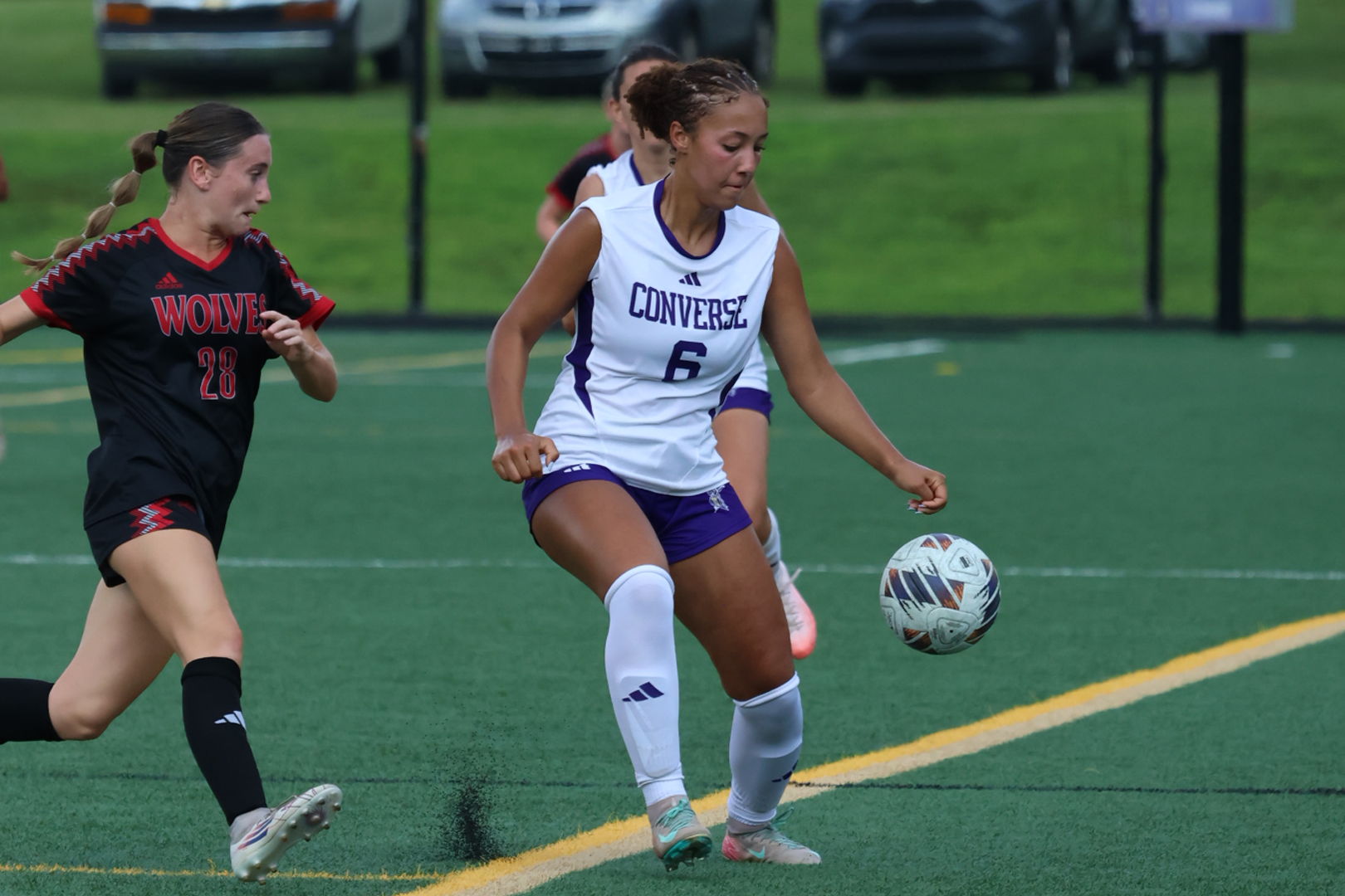 Sierra Criner controls the ball while surrounded by two Newberry defenders
