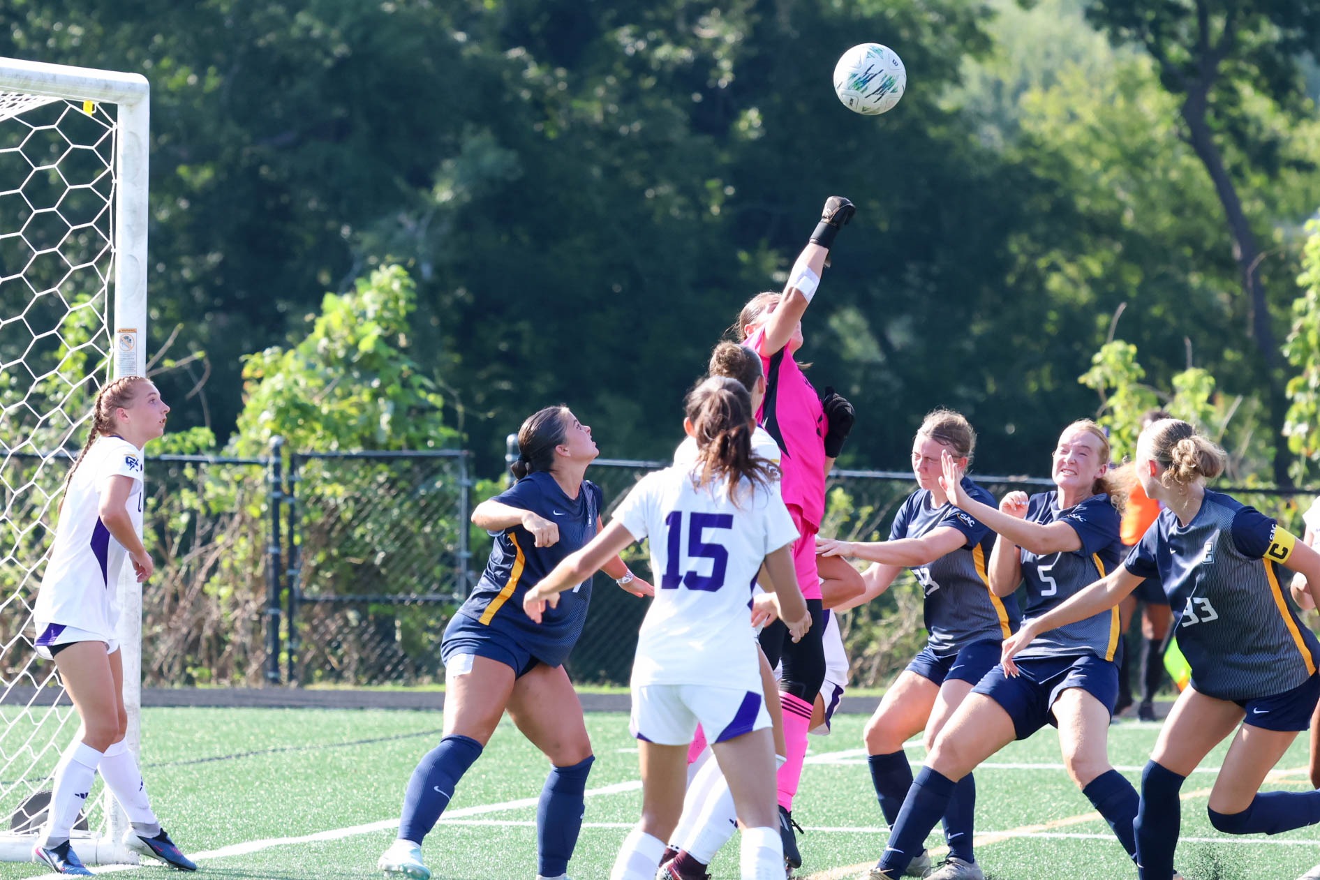 Converse goalkeeper Sofia Casares Herrasti punches the ball away from the goal surrounded by opposing players
