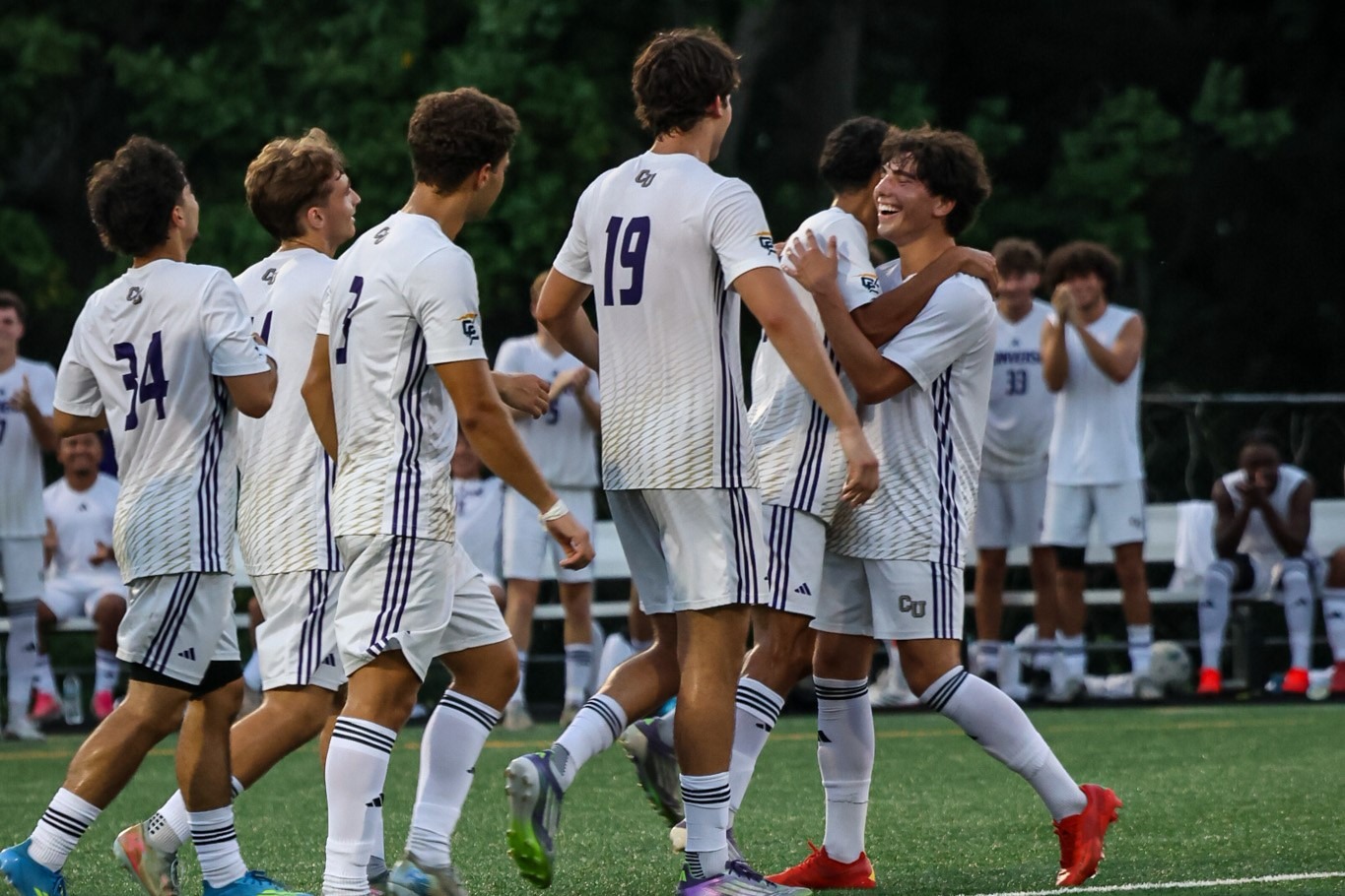 The Converse men's soccer team celebrates a goal