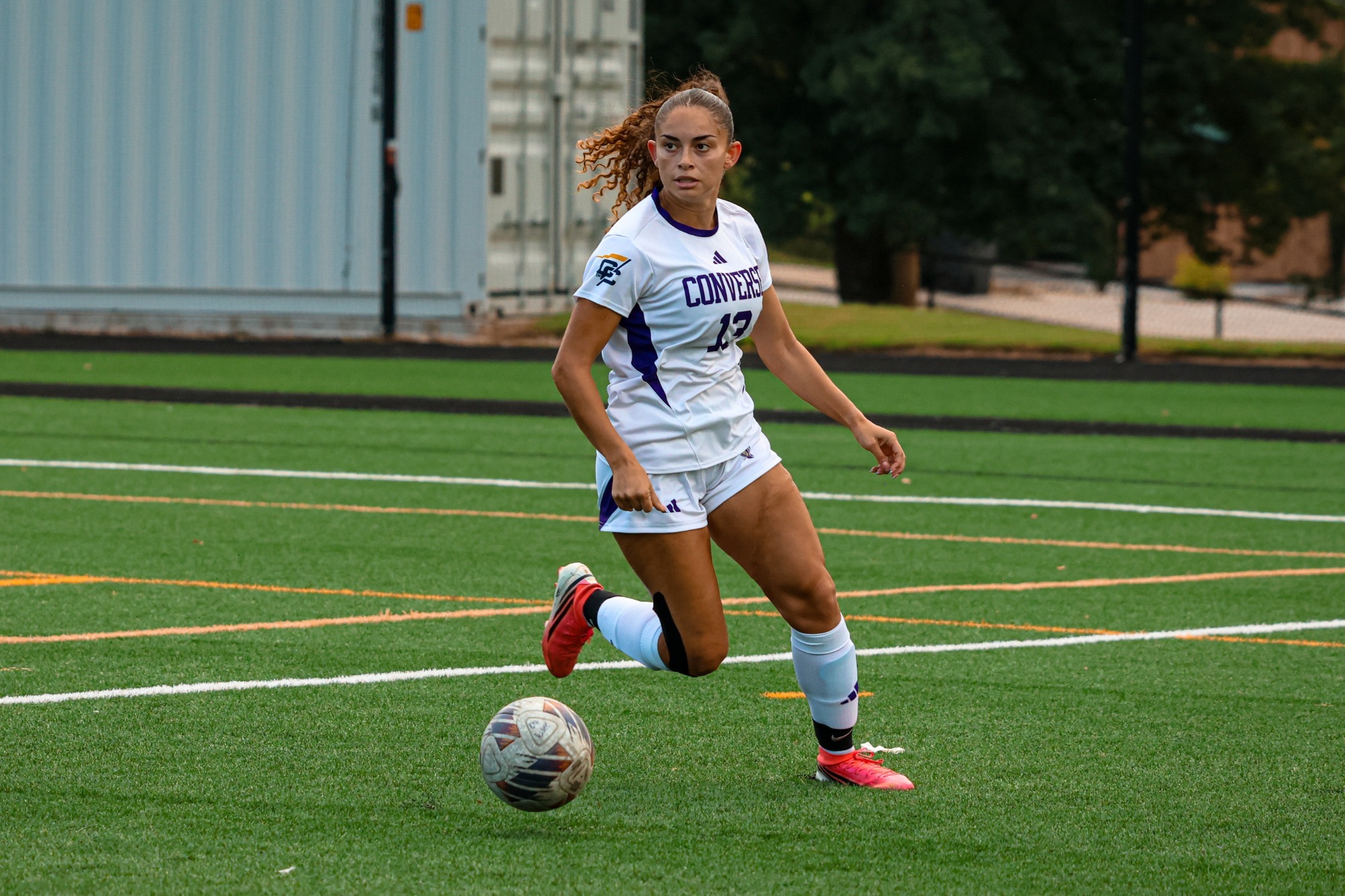 Emily Vargas looks up-field while dribbling the ball