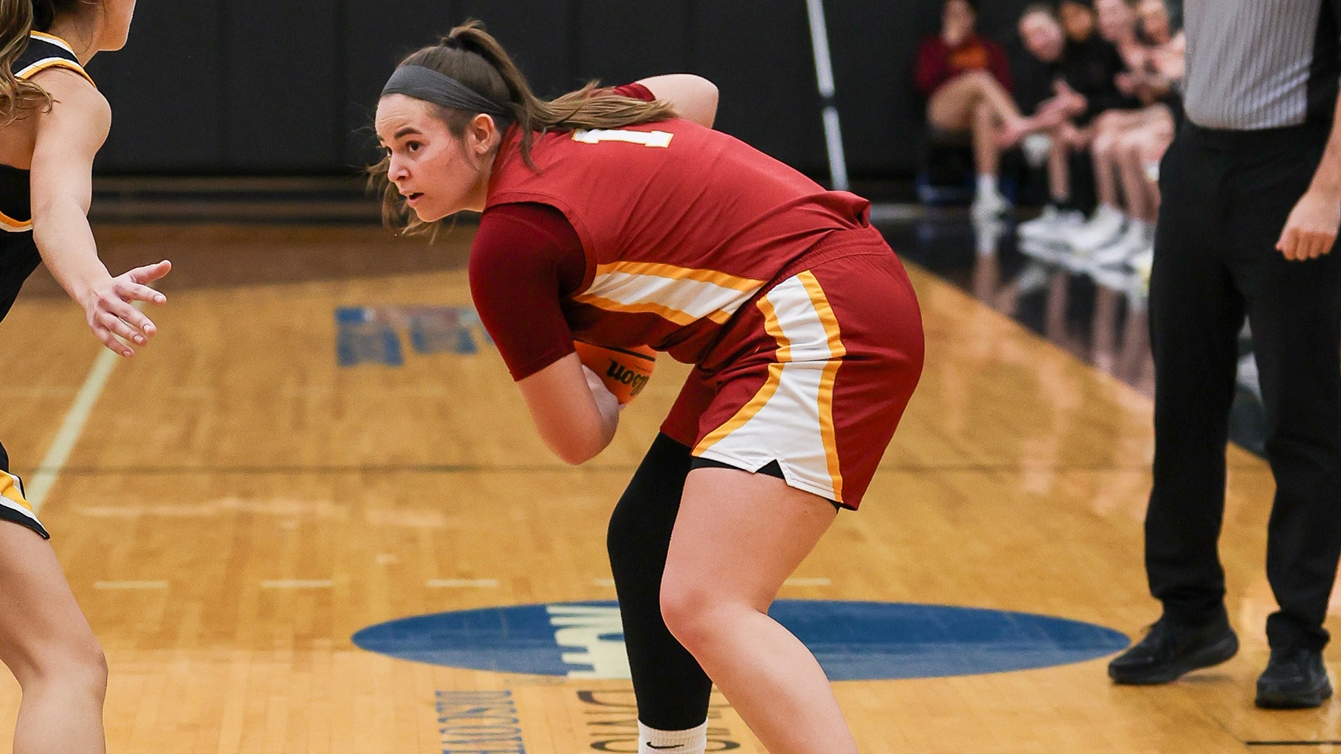 Ellie Pollock-Ballard holding basketball away from defender