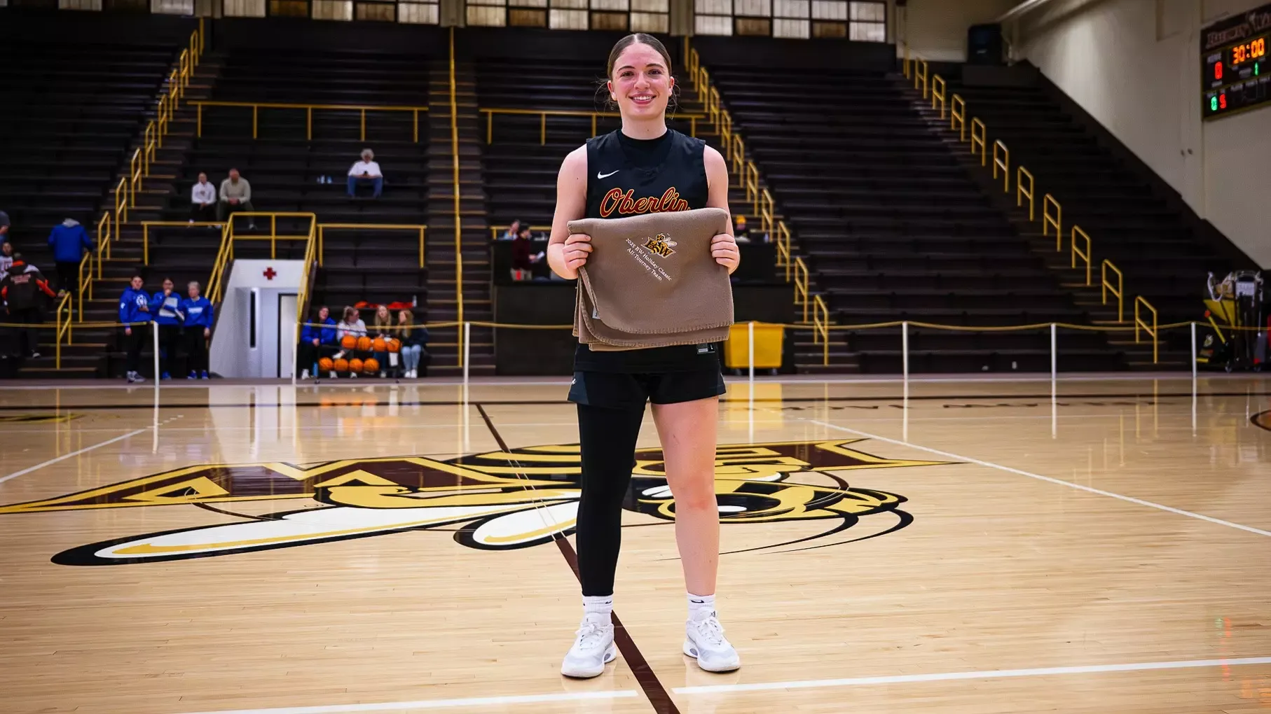 Noa Brown standing with a blanket after being named to the Baldwin Wallace Holiday Classic All-Tournament Team