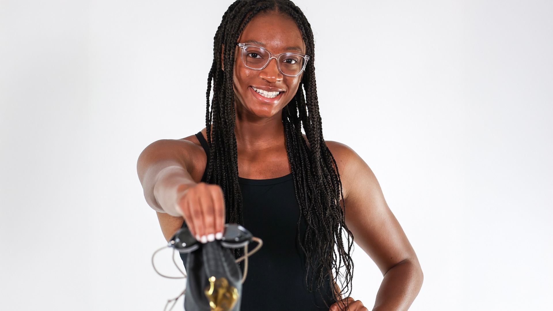 Nyrobi Whifield smiling, holding swim goggles