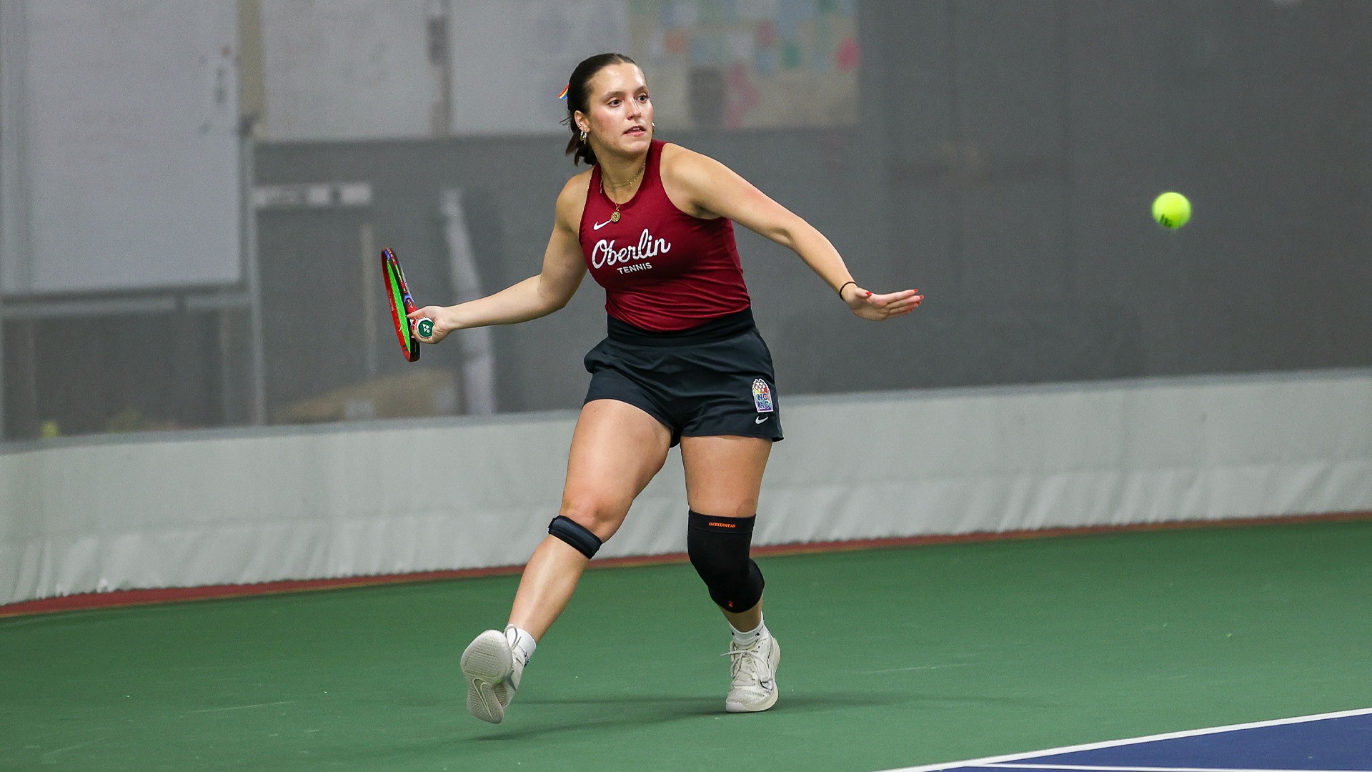 Anna Pastore winding up to return a tennis ball