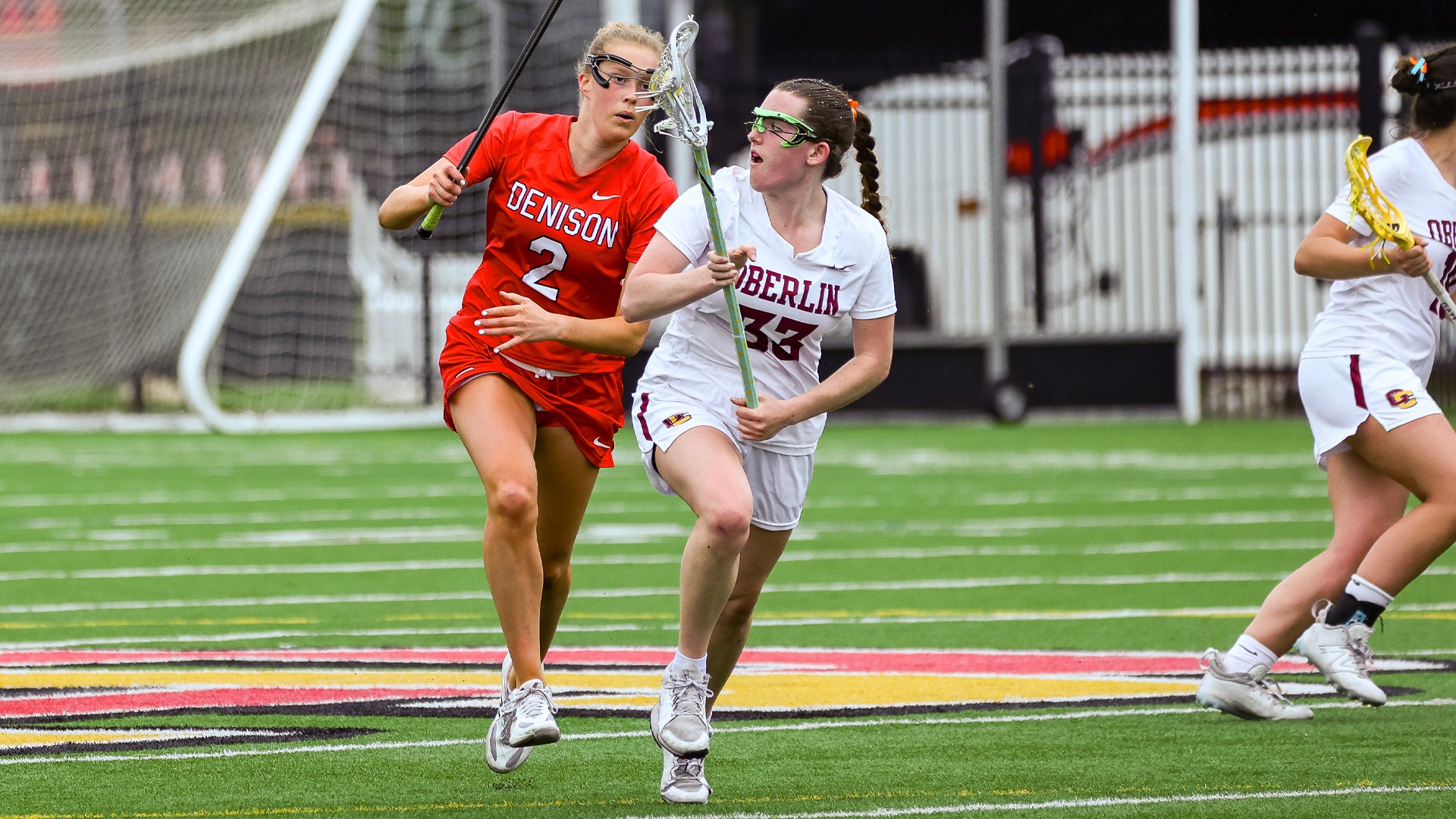 Rachel Reiter running away from a defender with the ball in her lacrosse stick