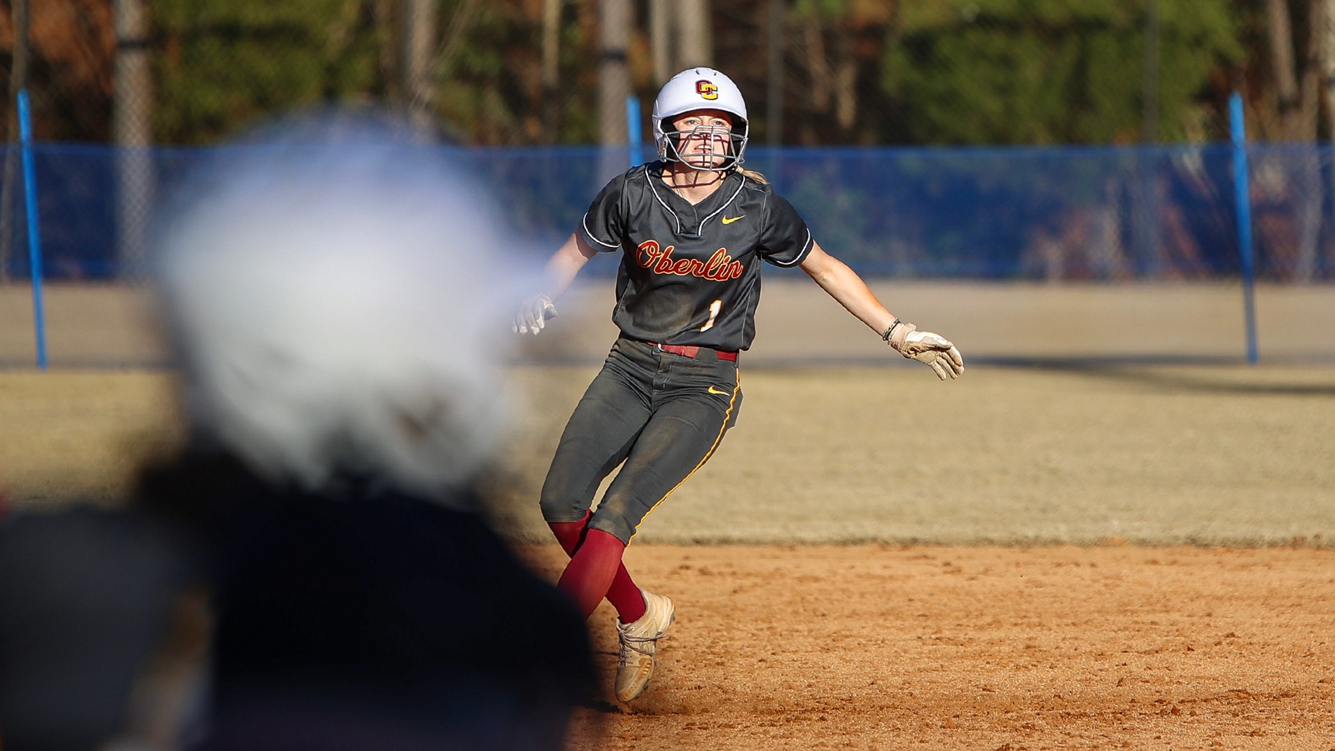 Hailey Alspach looking up in the air while running between bases