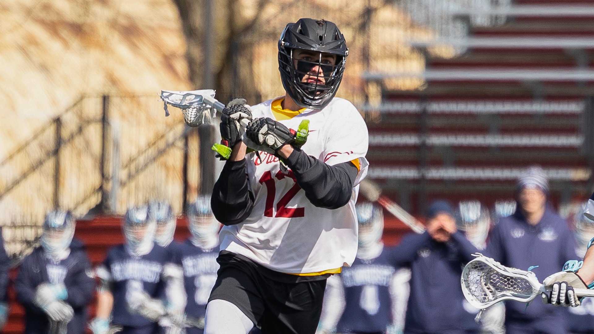 Cooper Zancosky running, about to pass the lacrosse ball