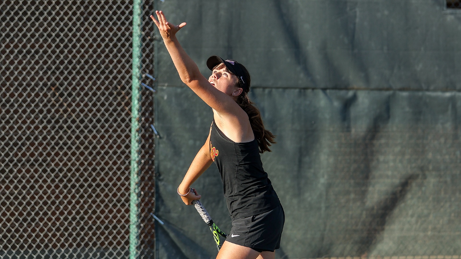 Scarlett Kingston serving the ball and looking up