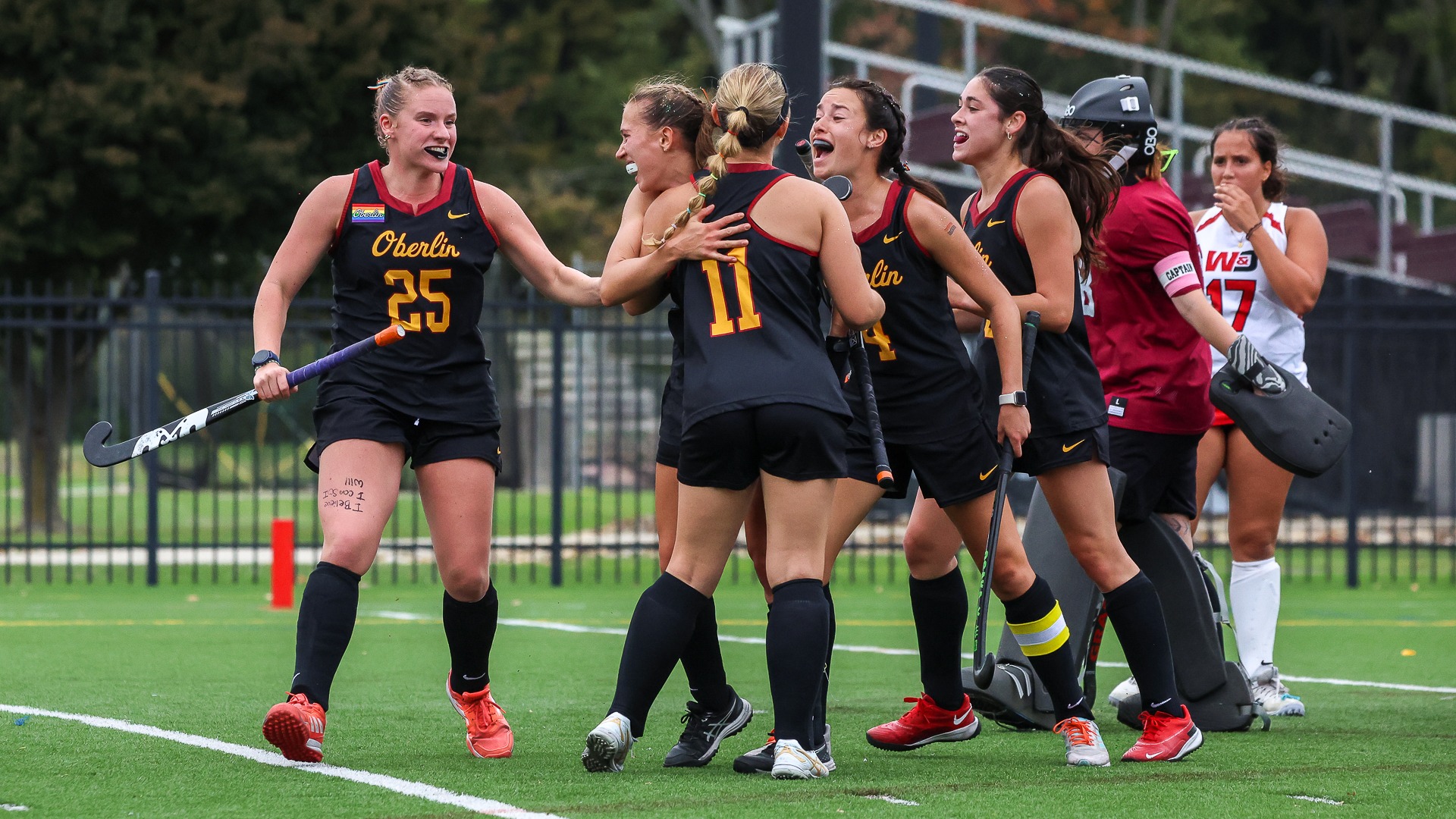 Field hockey team celebrates after Bella Tilford scores a goal
