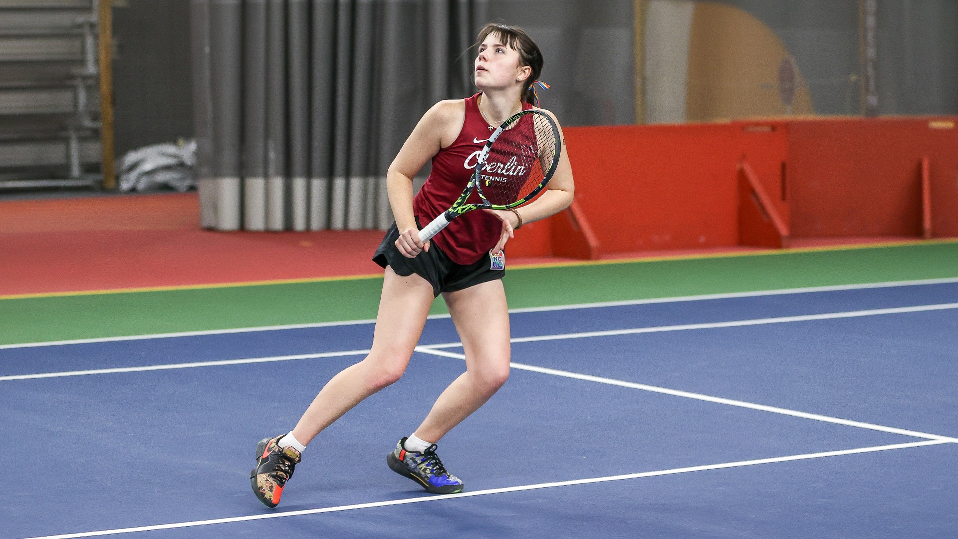 Scarlett Kingston looking up at a tennis ball in the air