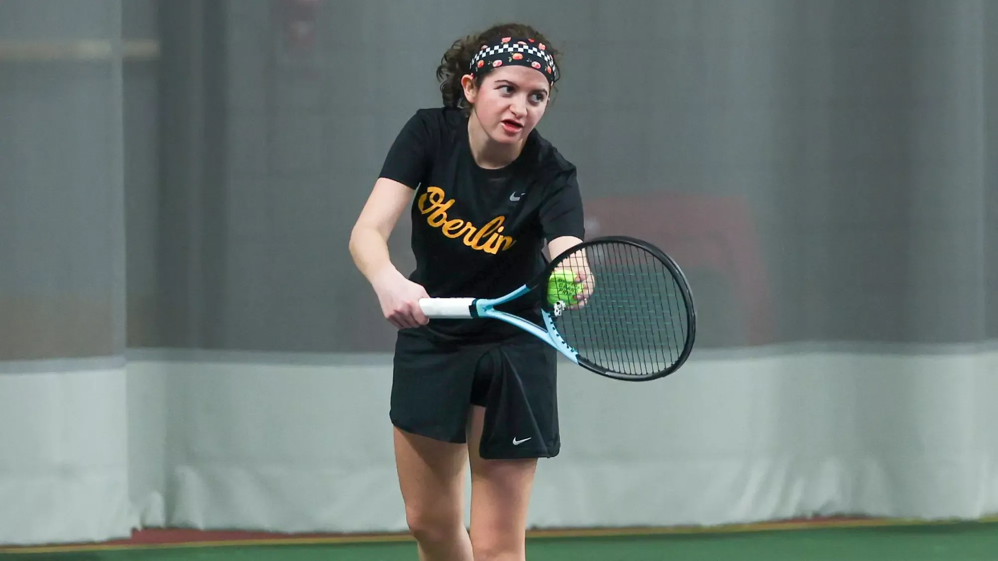 Eva Lopez preparing to lift the tennis ball to serve