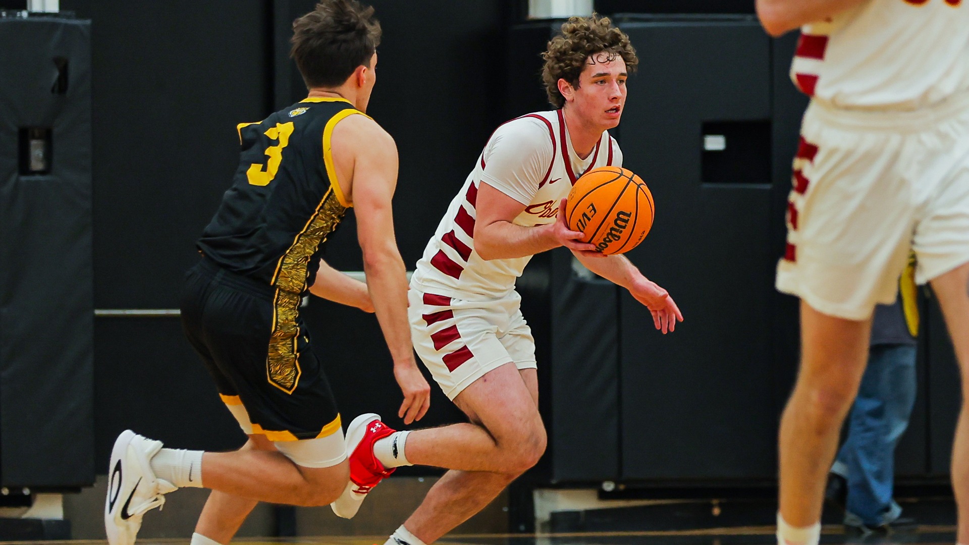 Augustus Donohue dribbles the ball down to the offensive side of the court