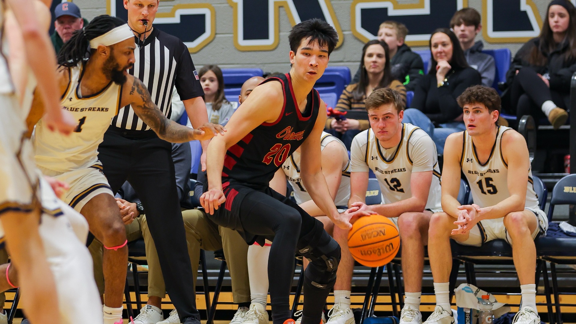 JJ Gray dribbles the ball around a defender 