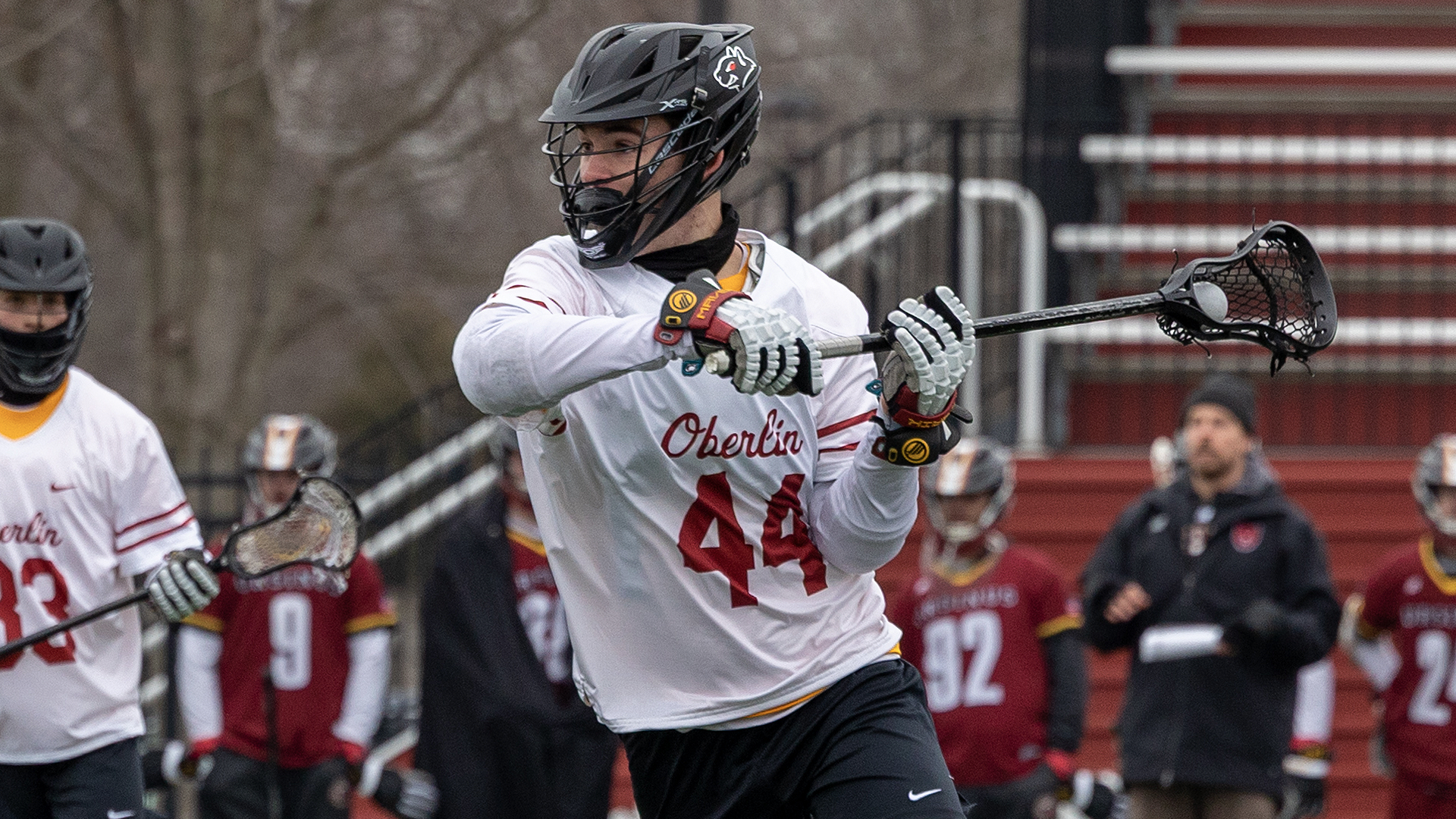 Andrew Rosa running with the lacrosse ball in his stick, looking to the right
