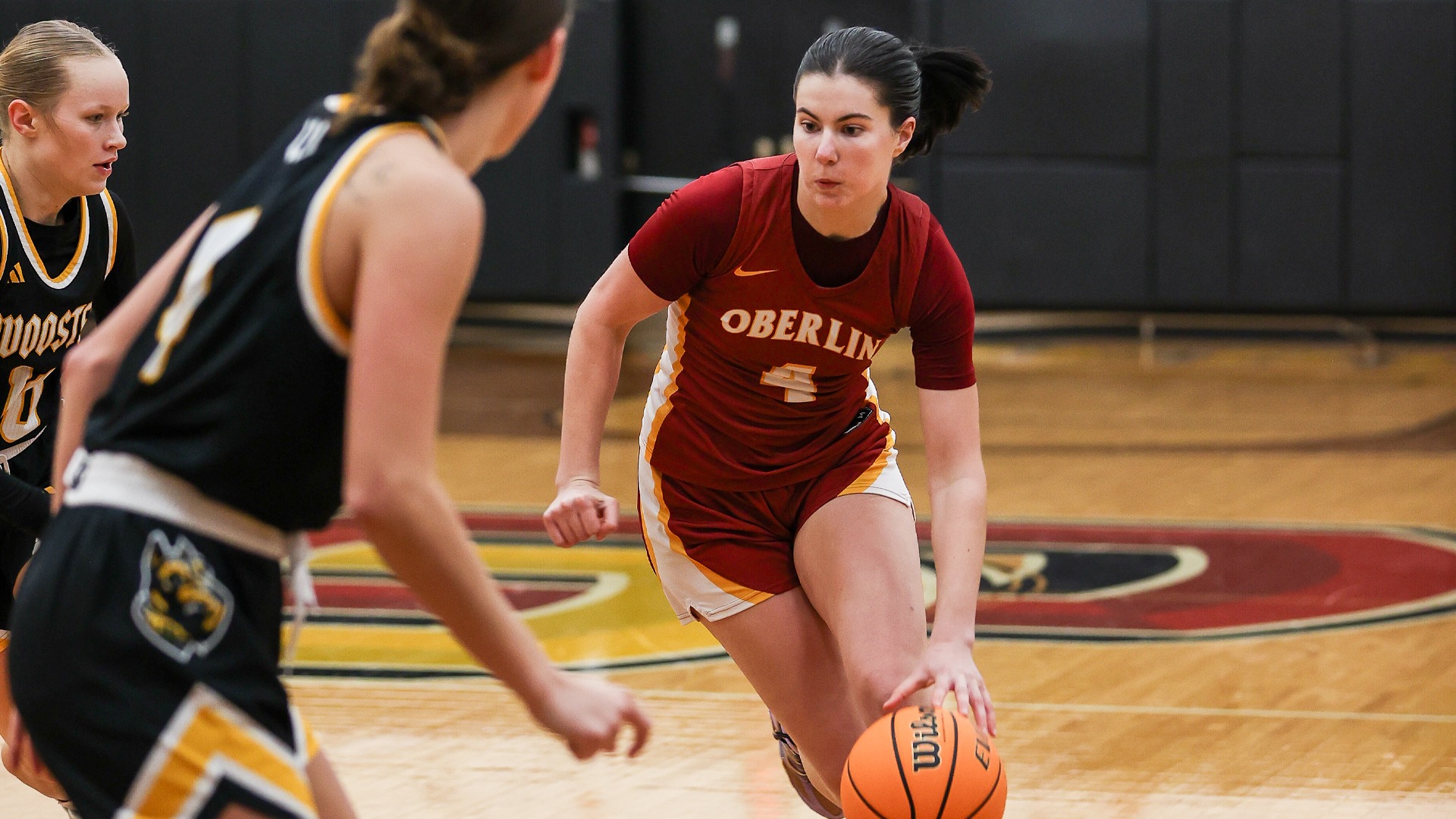 Angela Kumler dribbles the ball around some defenders